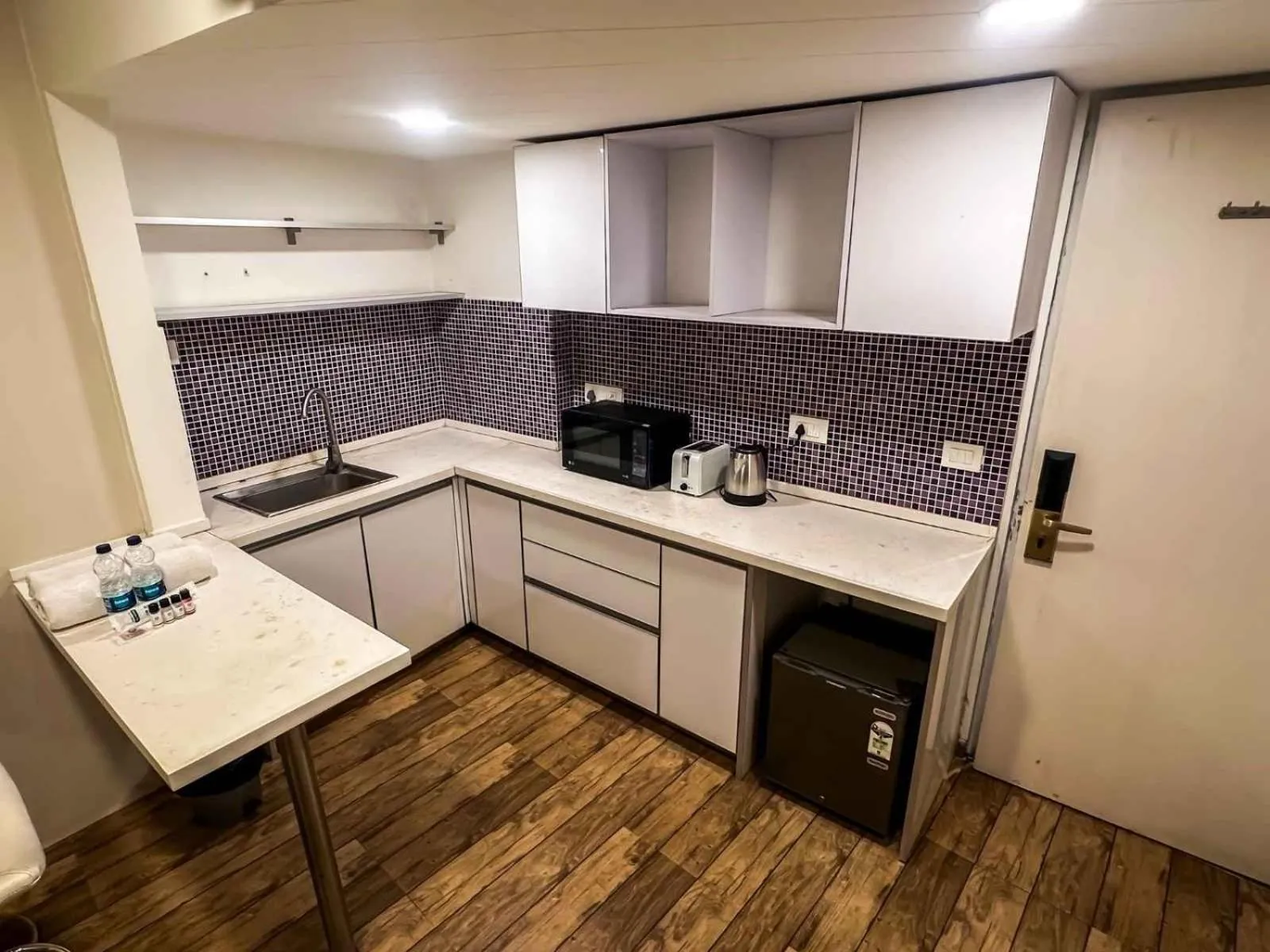 Kitchen or kitchenette in Ambition studio apartment at rajhans belliza