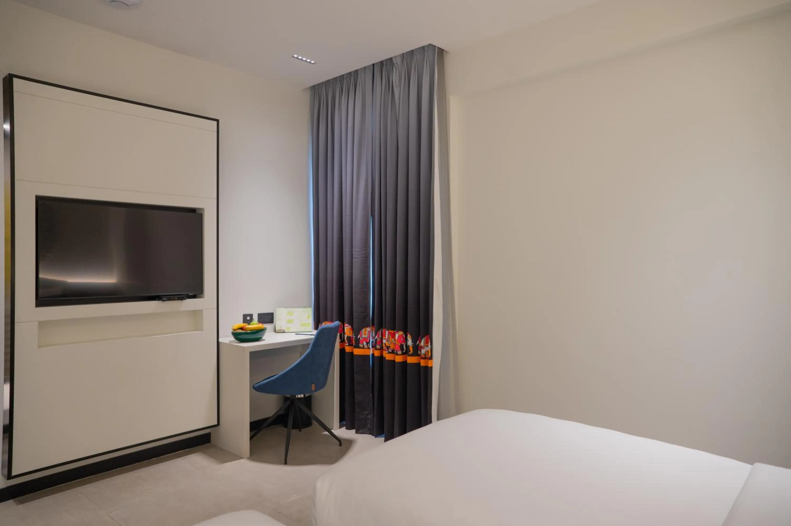 Communal lounge/ TV room, Bed in ZIBE Luxe Kakinada by GRT Hotels