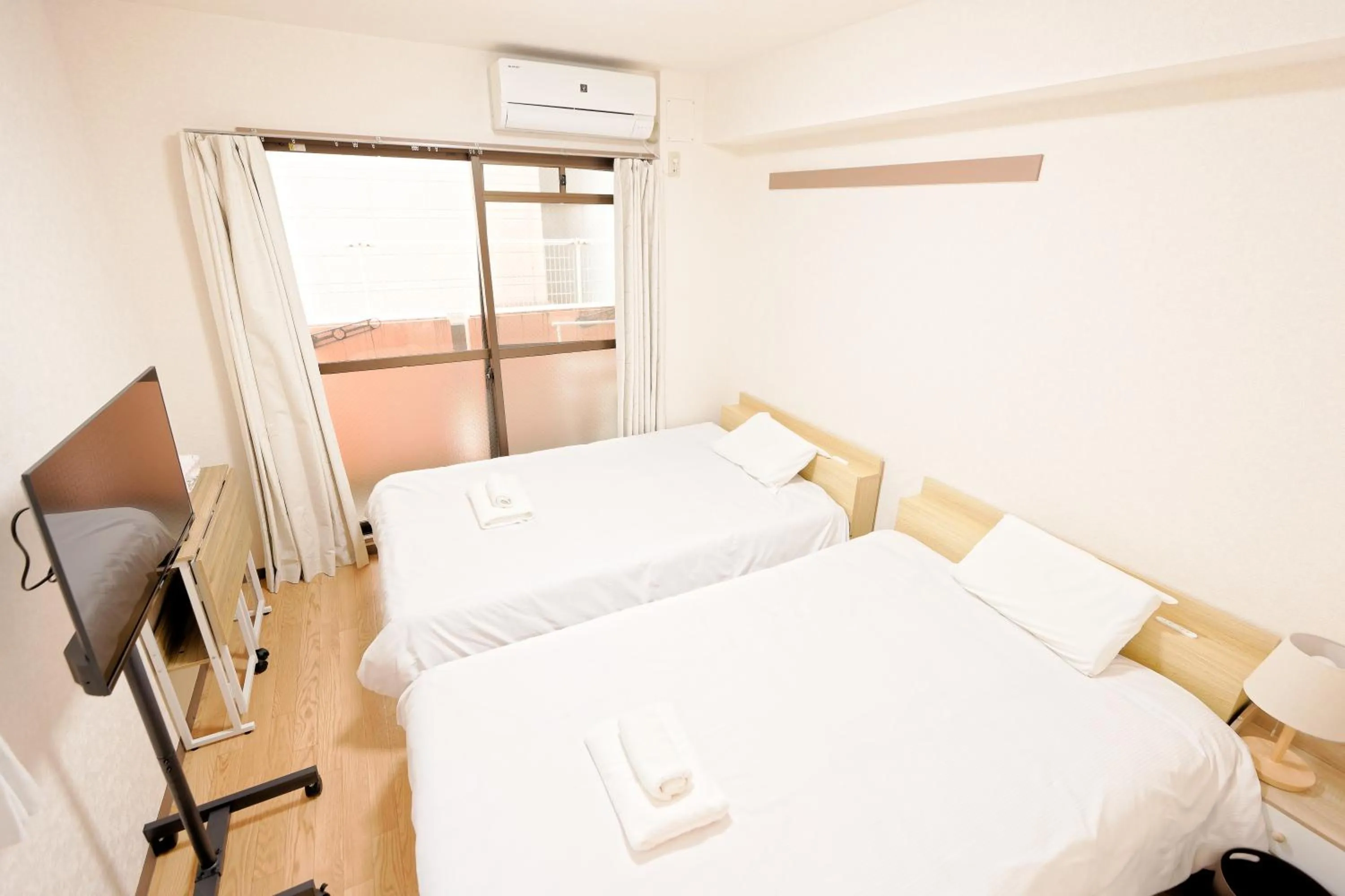 Bed in Shinjuku Waseda Earthtone Apartment
