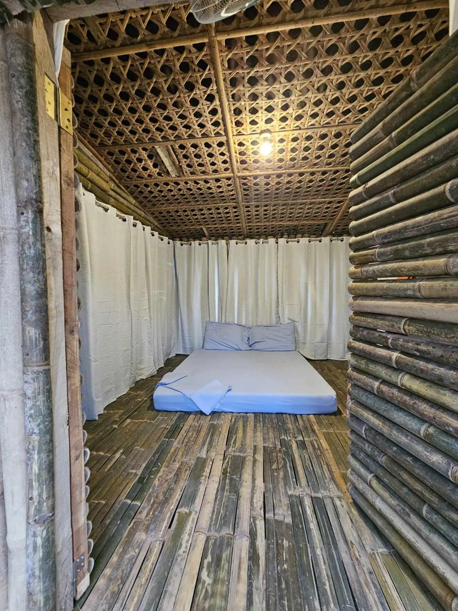 Bed in Tambayan Rooms and Cottages by SMS Hospitality