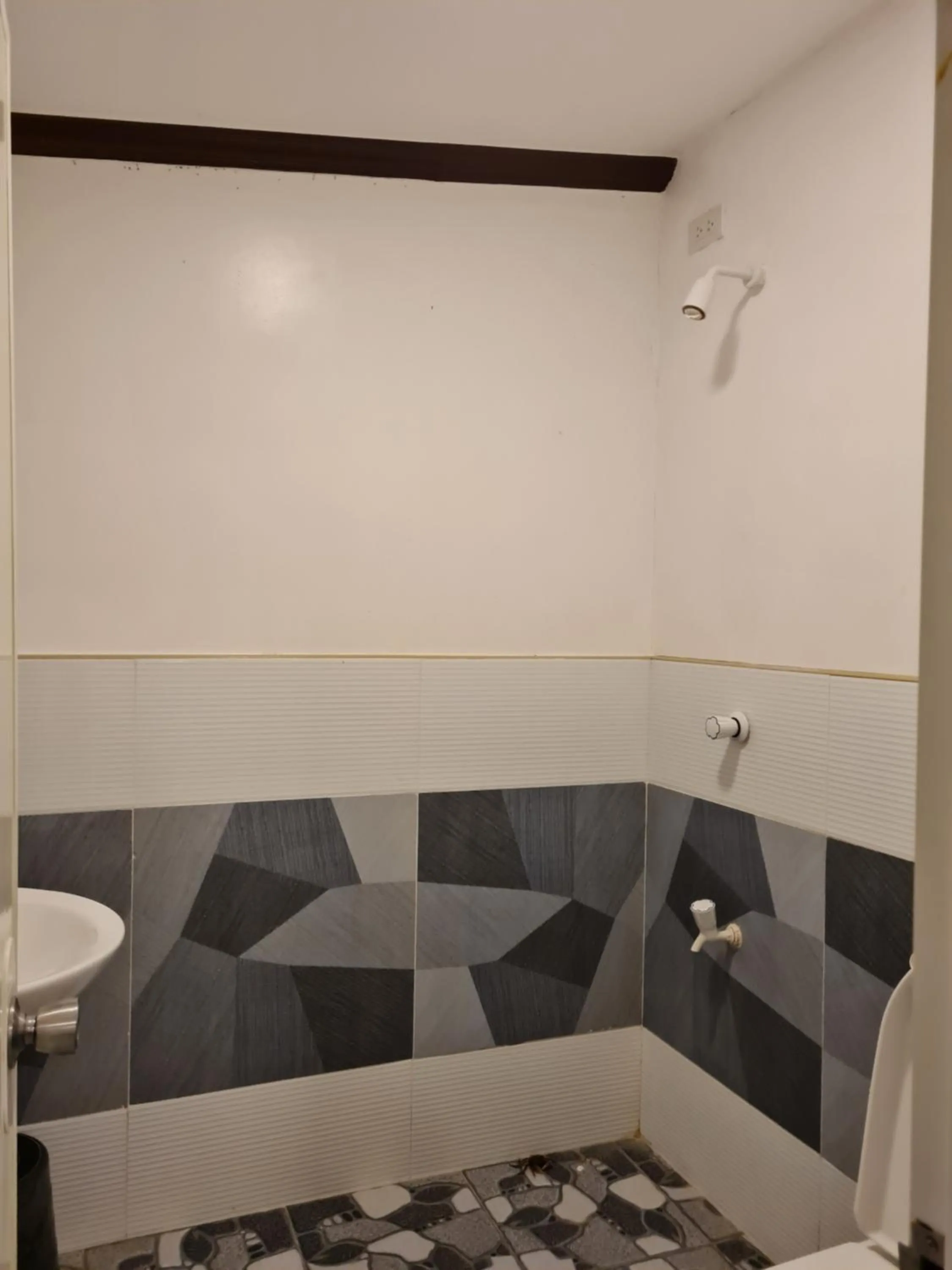 Shower in Tambayan Rooms and Cottages by SMS Hospitality