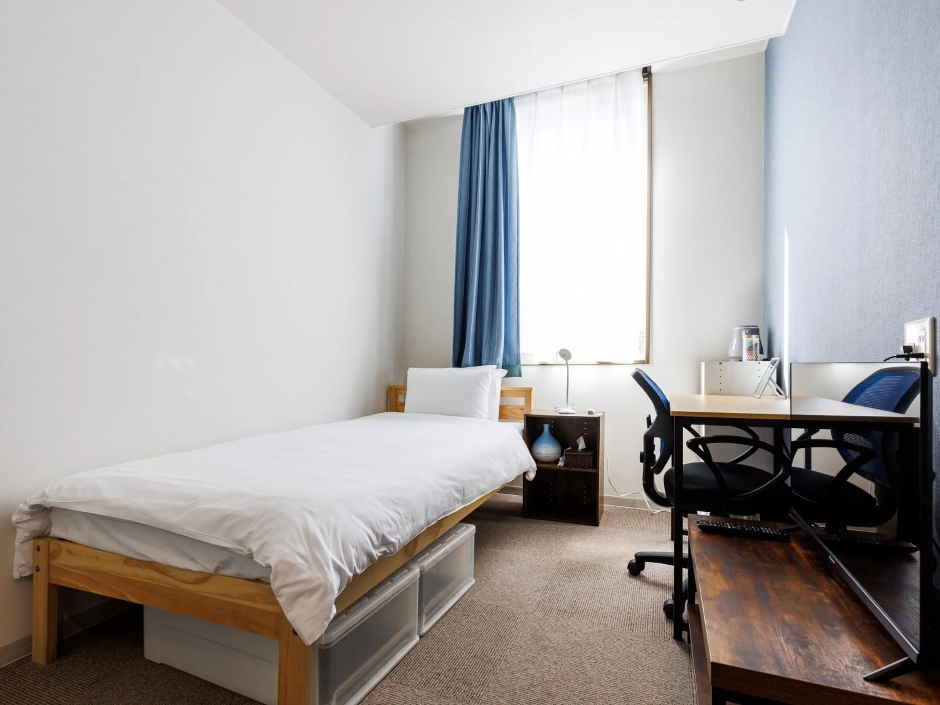 Bed in Tabist Kitami Athlete Stays