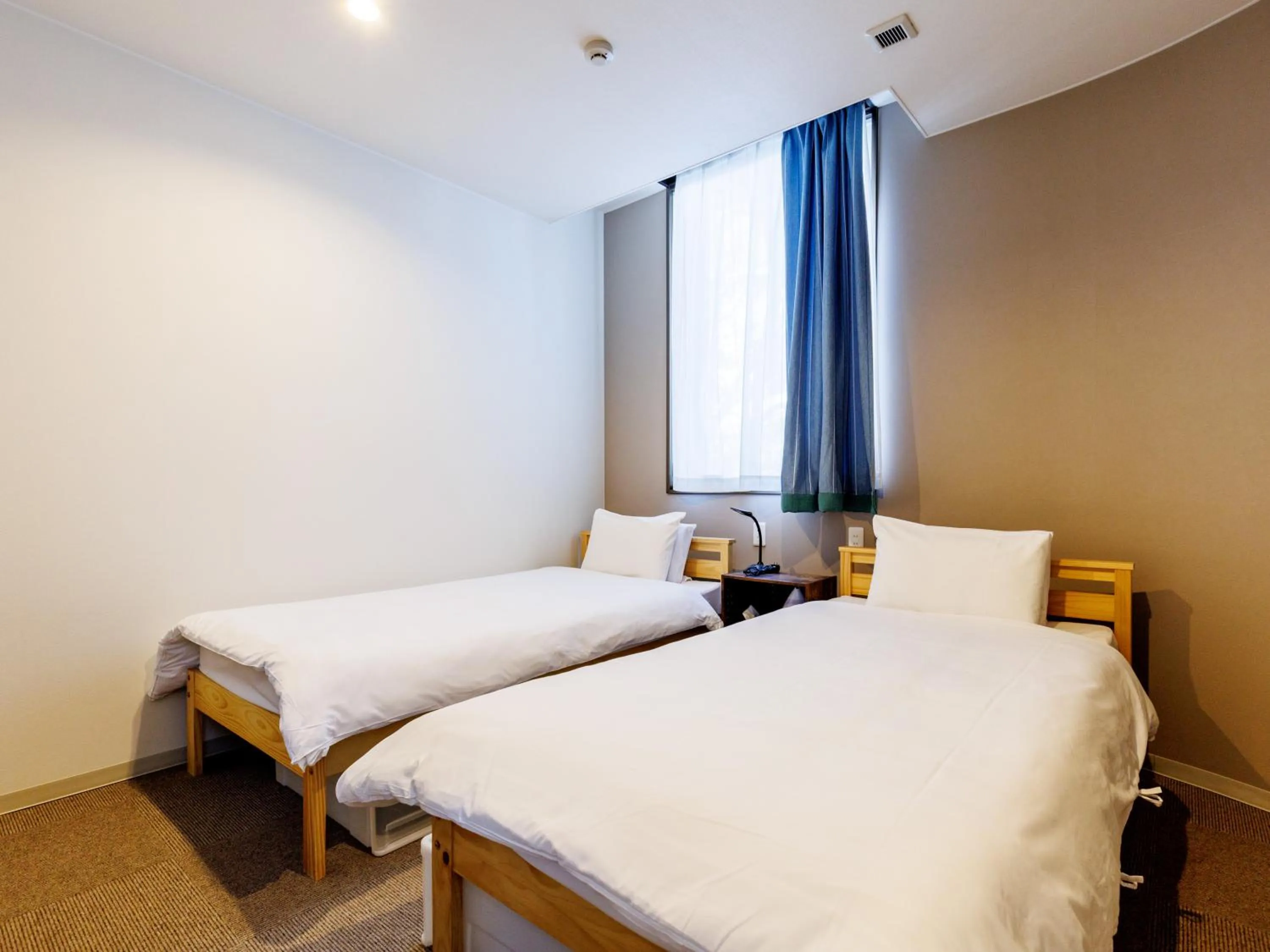 Bed in Tabist Kitami Athlete Stays