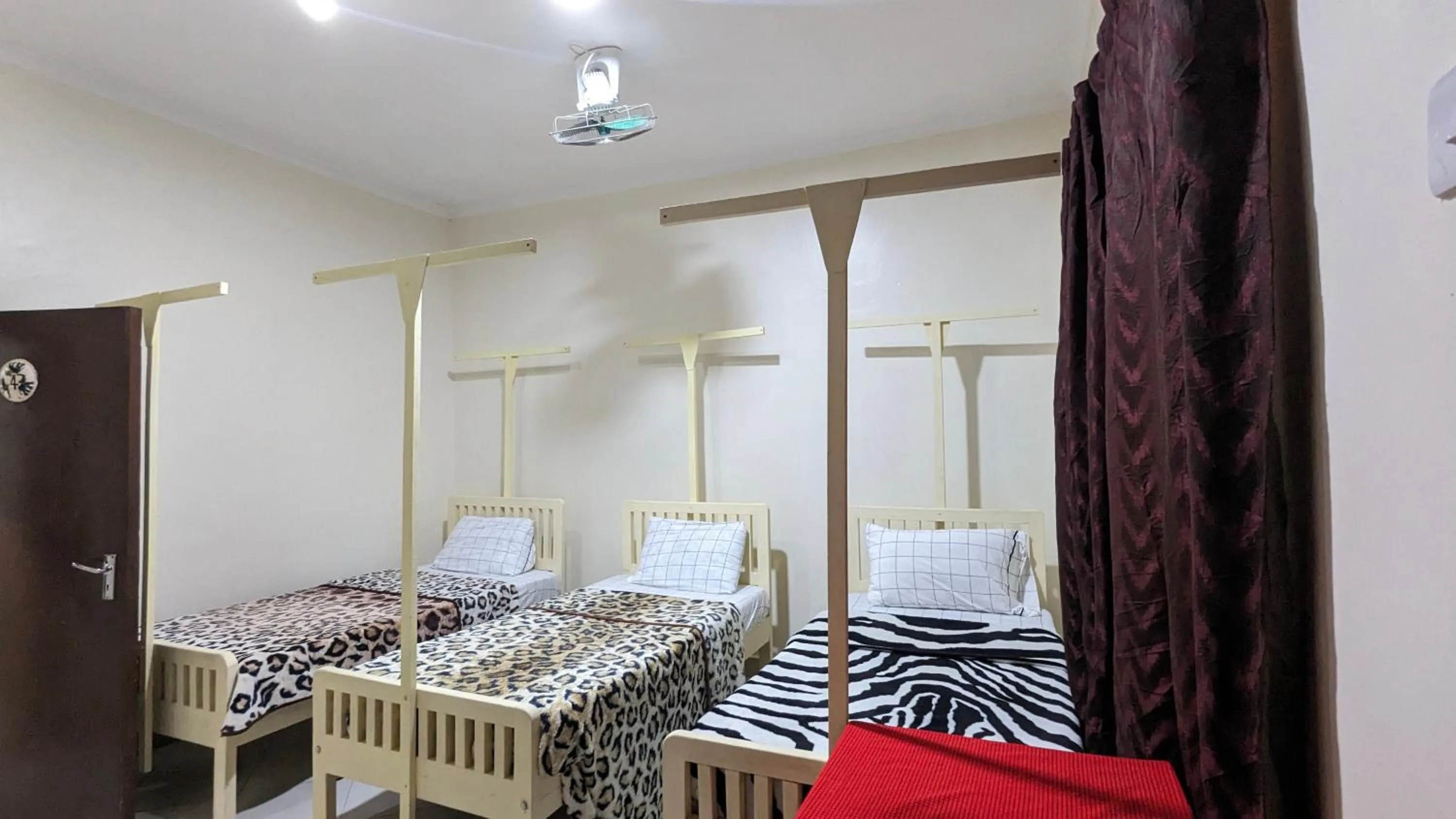 Bed in JACARANDA HOMESTAY