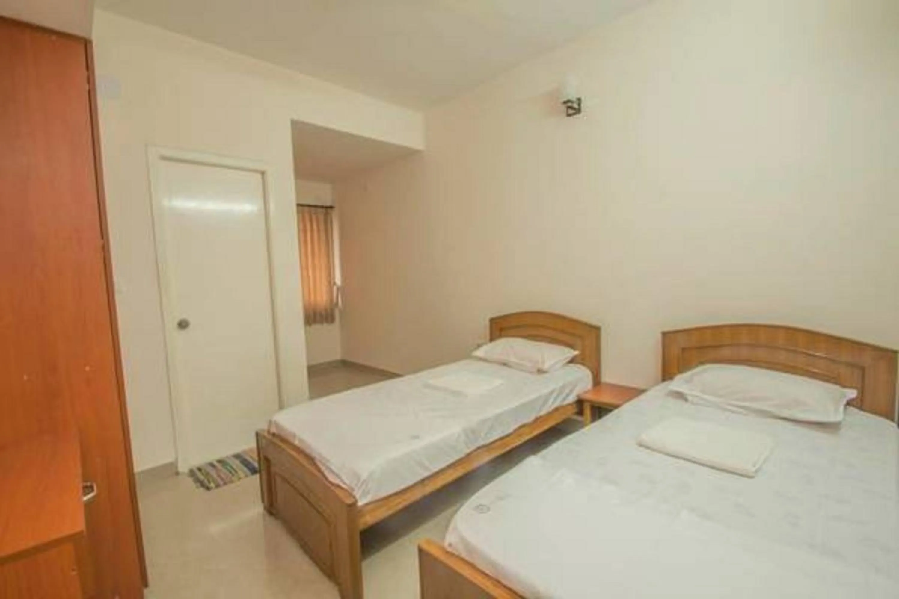 Bed in ThulasiRams Service Apartments