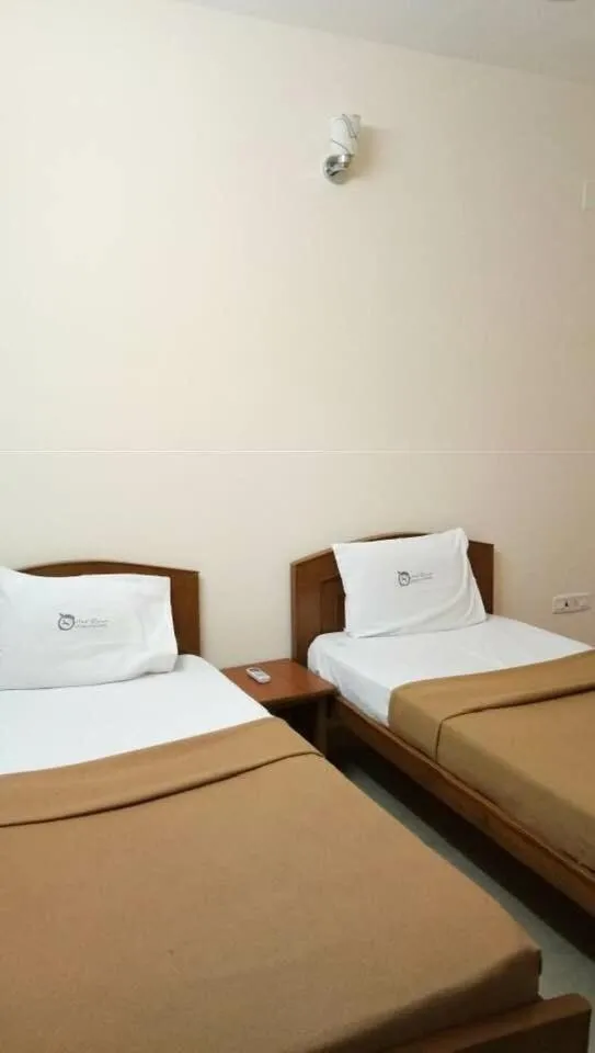Bed in ThulasiRams Service Apartments