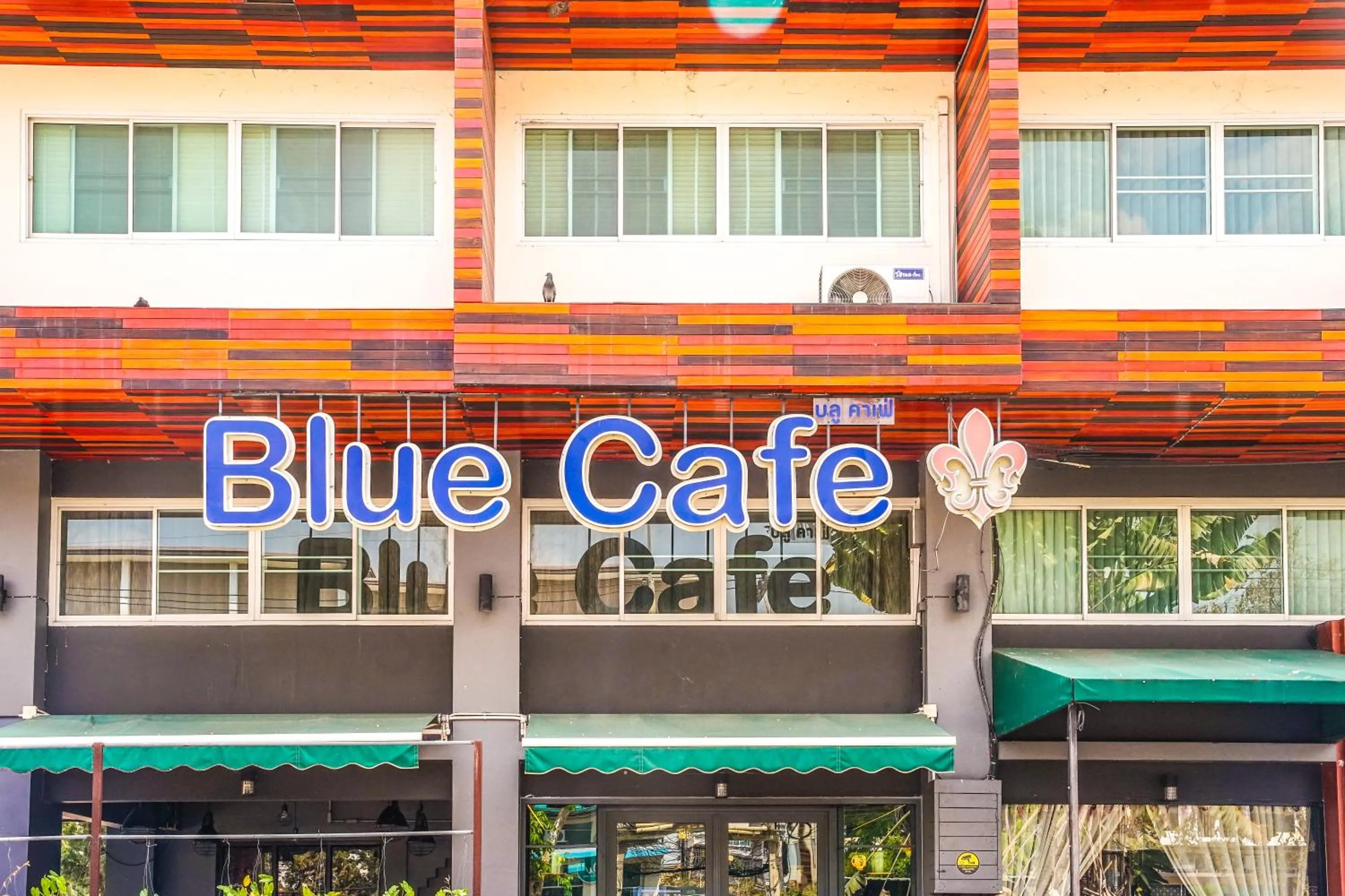 Property logo or sign in Blue cafe Apartments