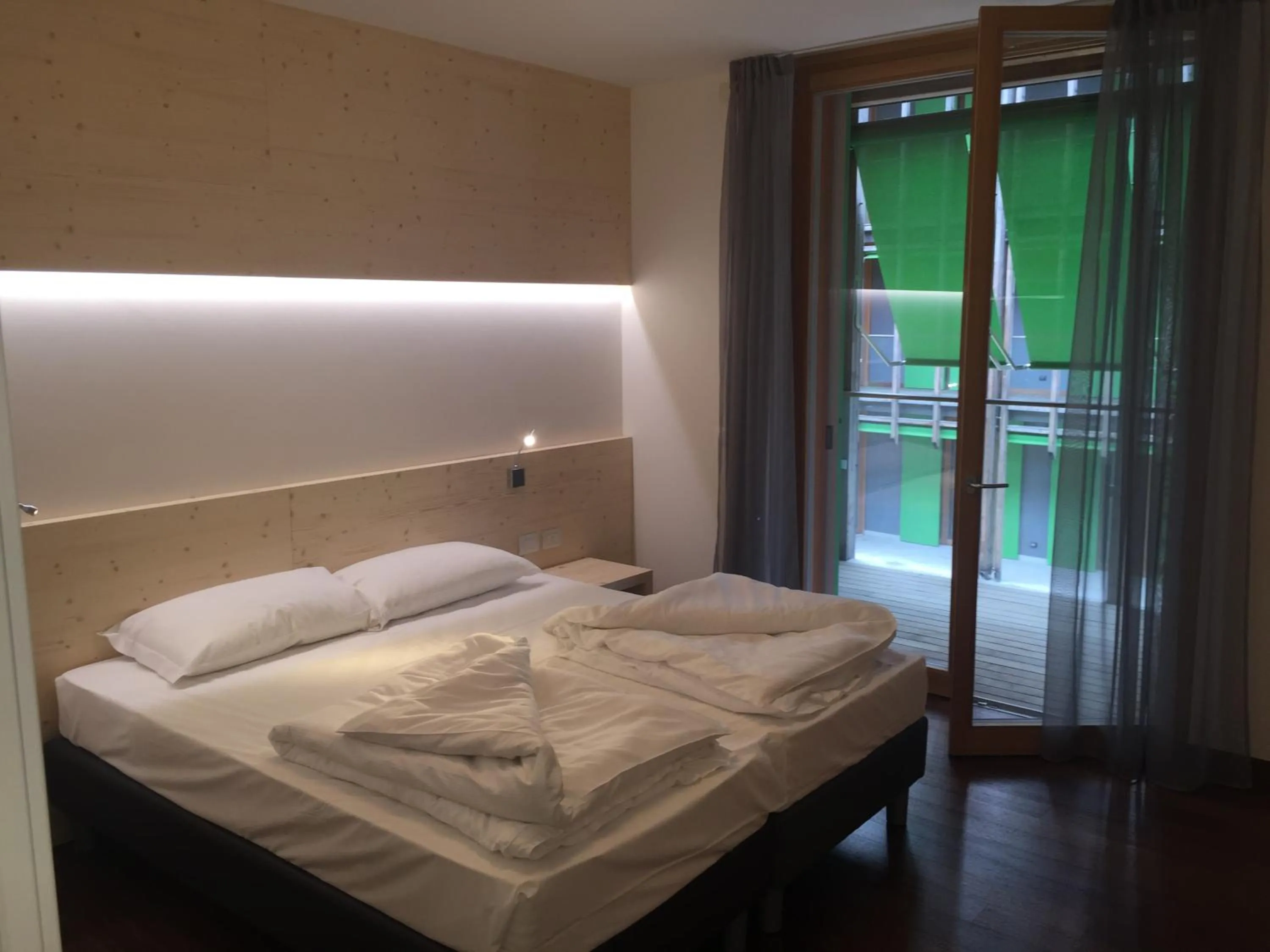 Bed in Komodo short stay apartments