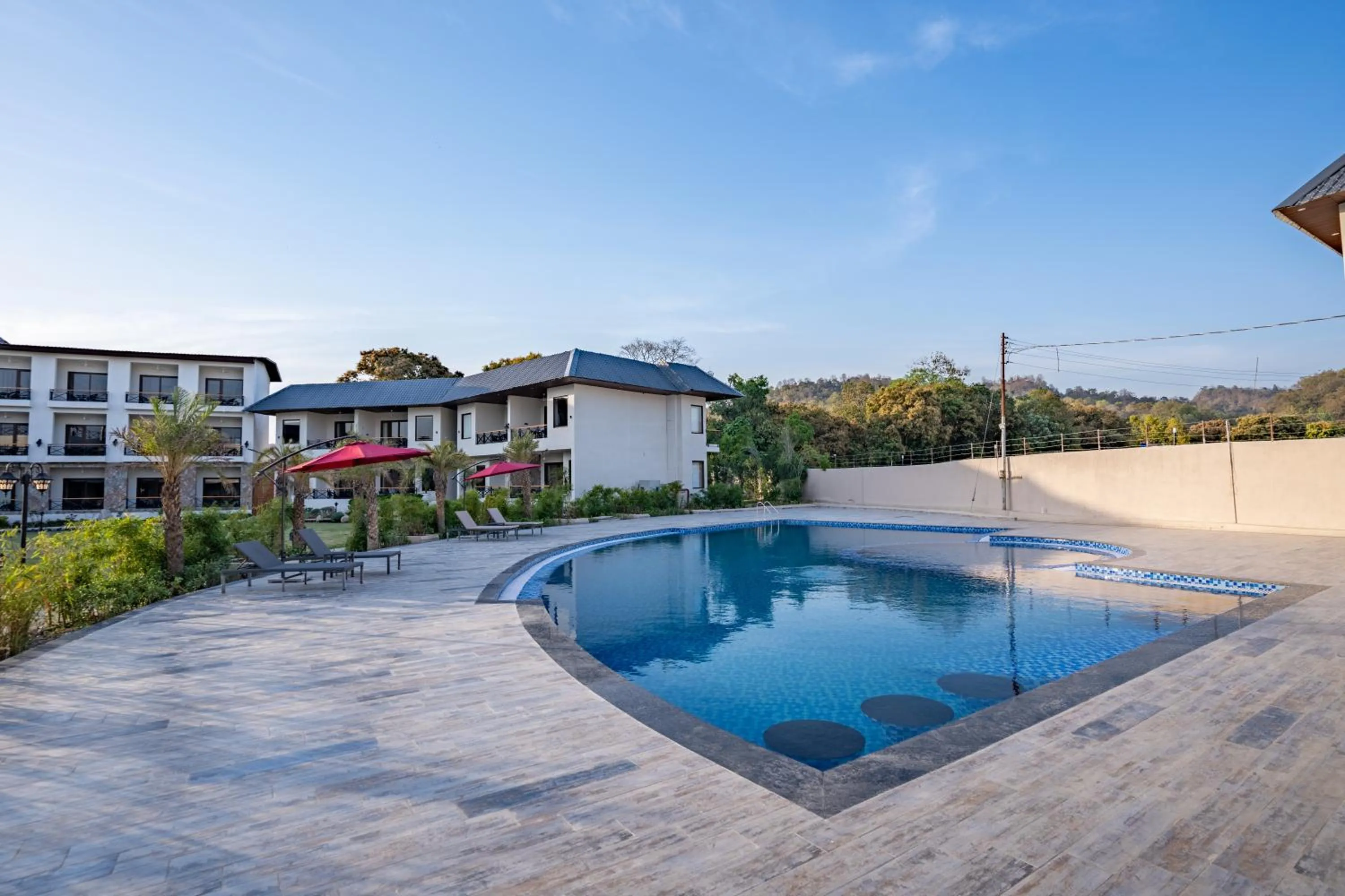 Swimming pool in Shervani Pebbles & Pines Resort & Spa, Corbett