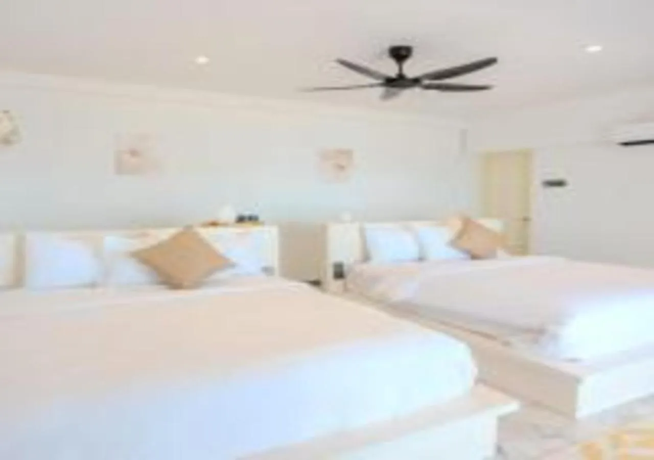 Bed in Suntai Villa, Beachfront Suites