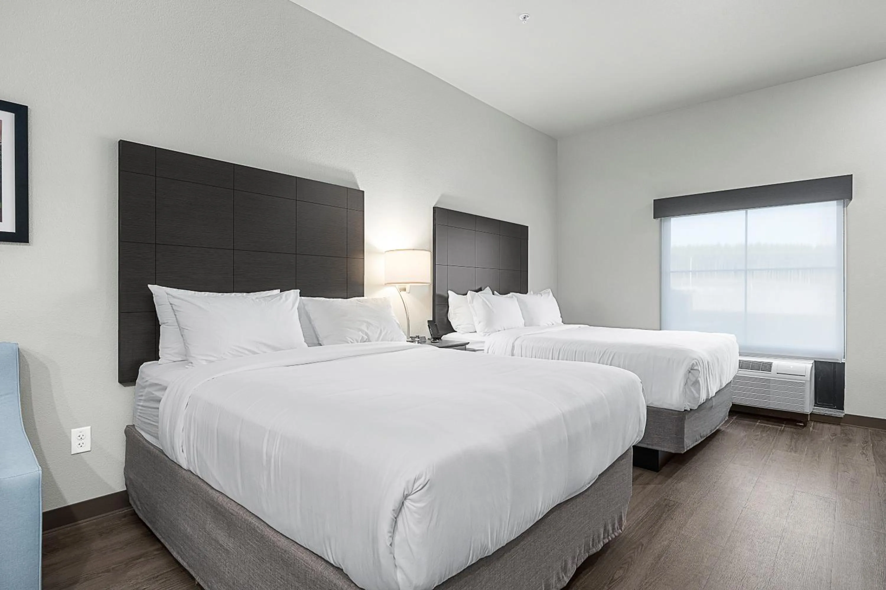 Bedroom, Bed in Riverstone Suites by Cobblestone Hotels - Chippewa Falls