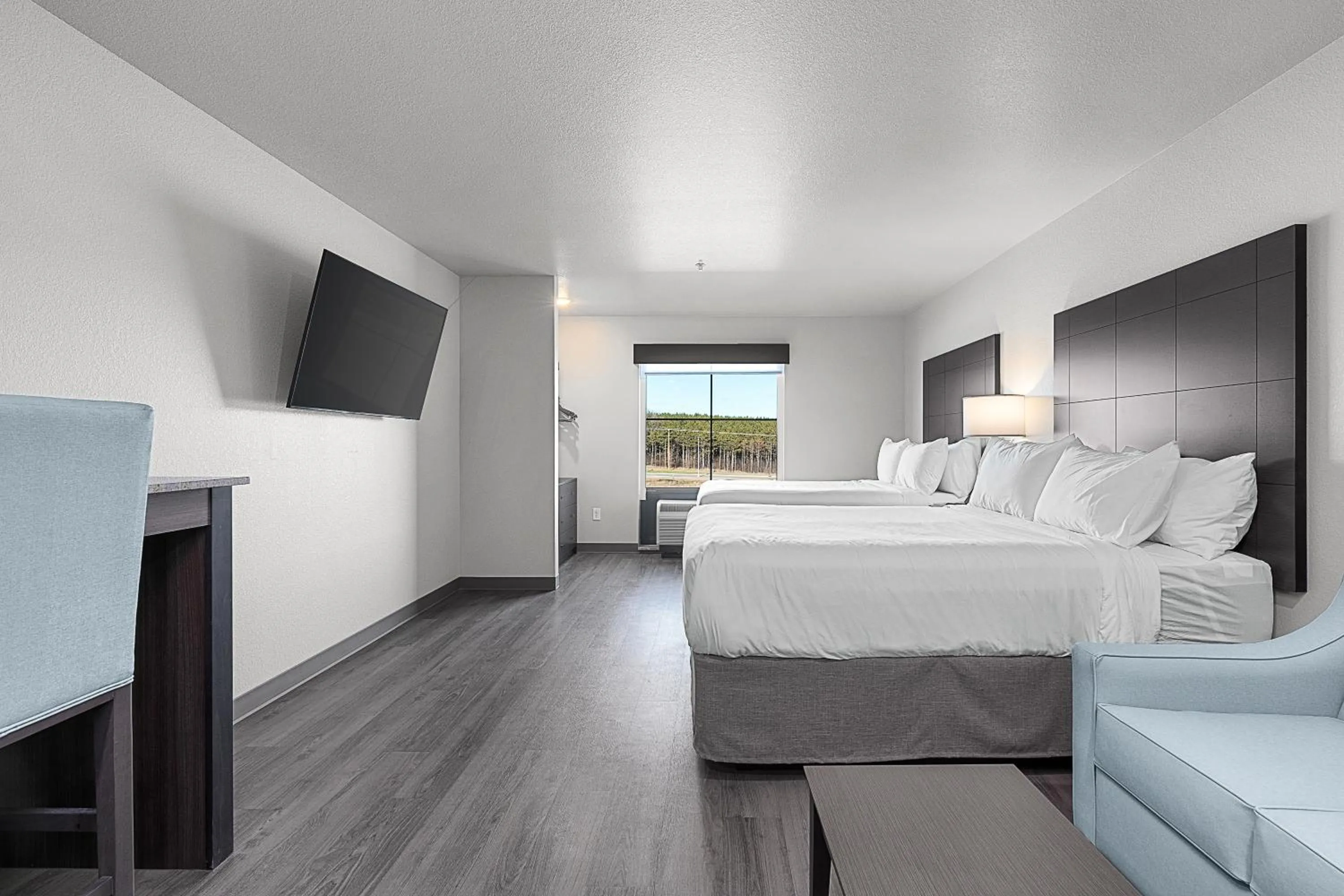 Bedroom, Bed in Riverstone Suites by Cobblestone Hotels - Chippewa Falls