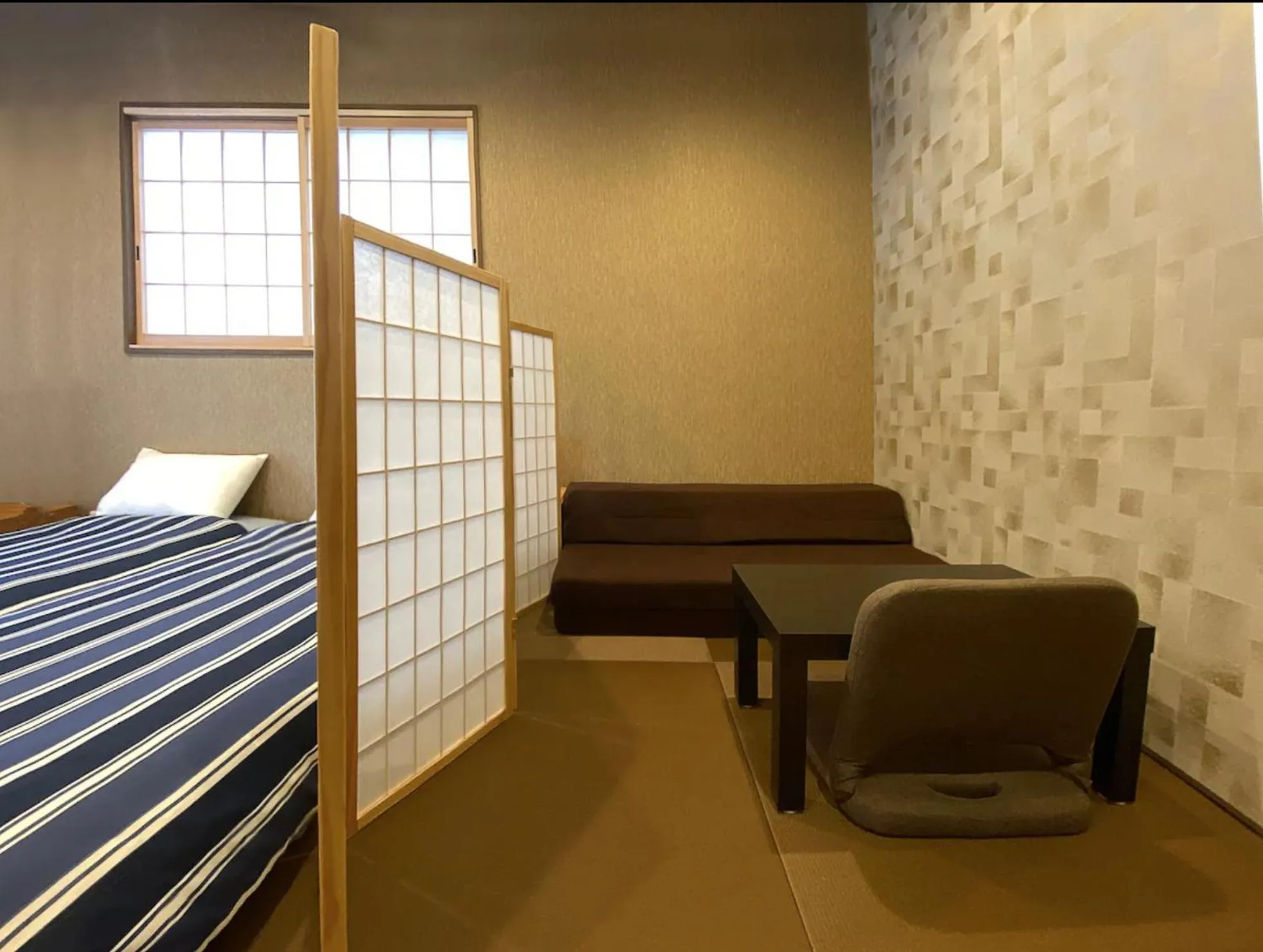 Seating area, Bed in My Home Inn Izumisano