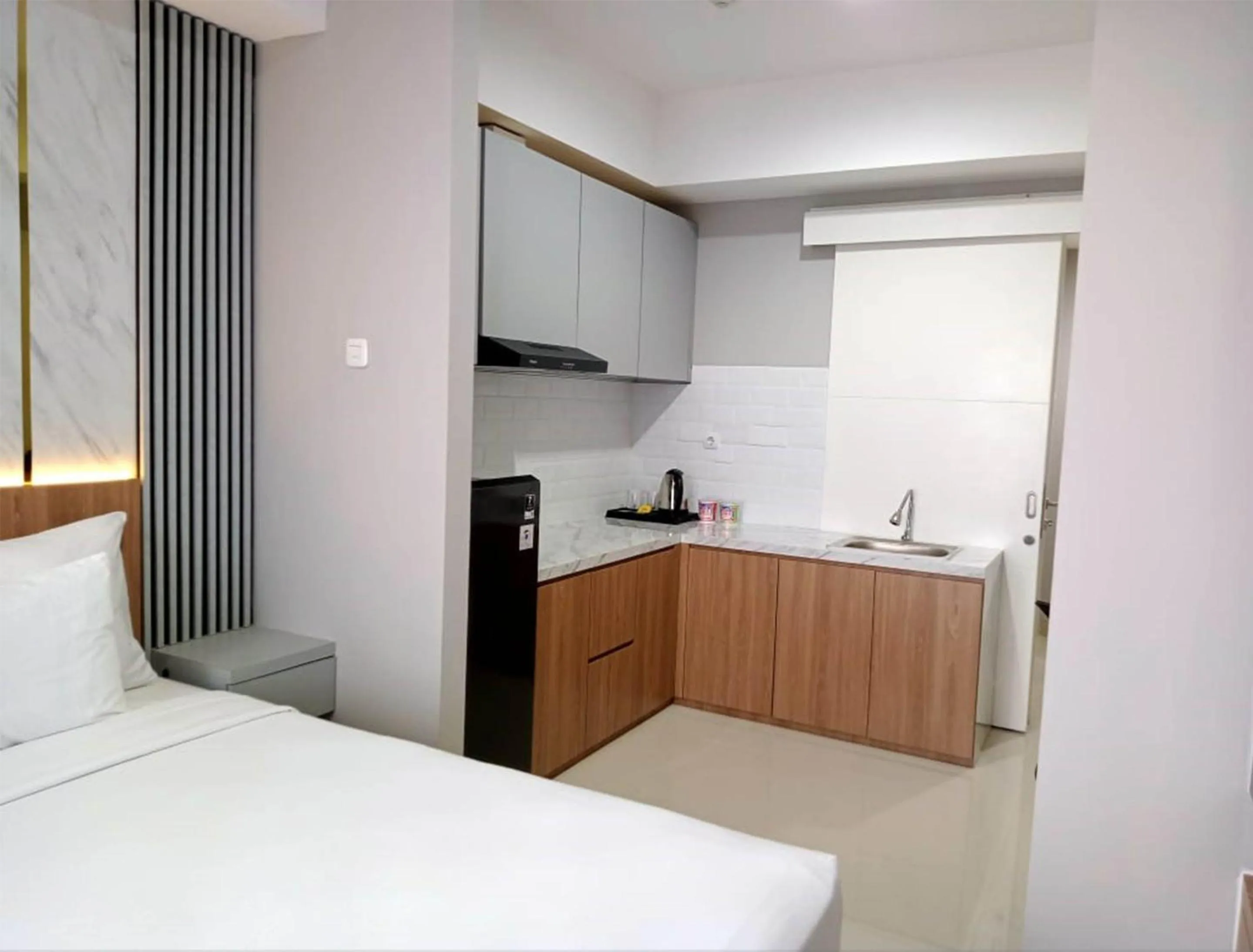 Kitchen or kitchenette, Bed in The Cozy Rooms at The Ayoma Residence, BSD Serpong