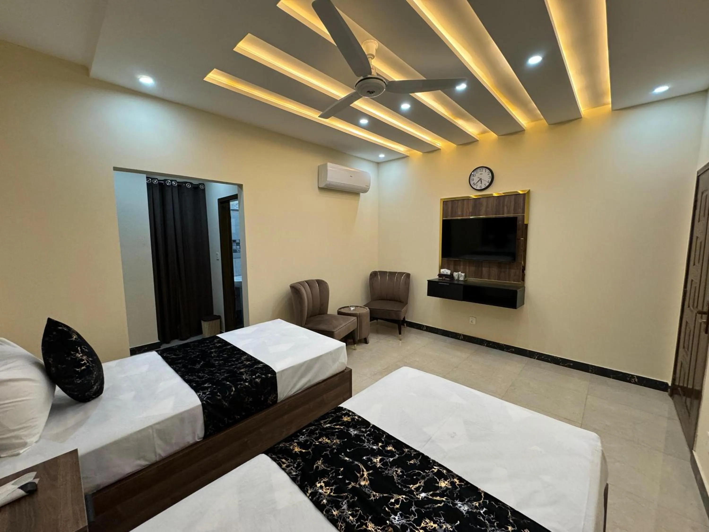 Living room, Bed in Gold Pine Hotel Lahore