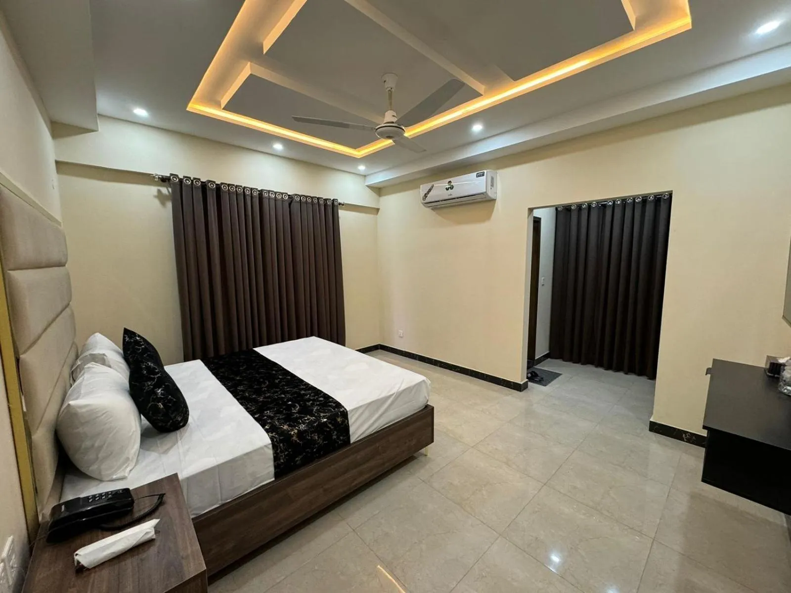 Living room, Bed in Gold Pine Hotel Lahore