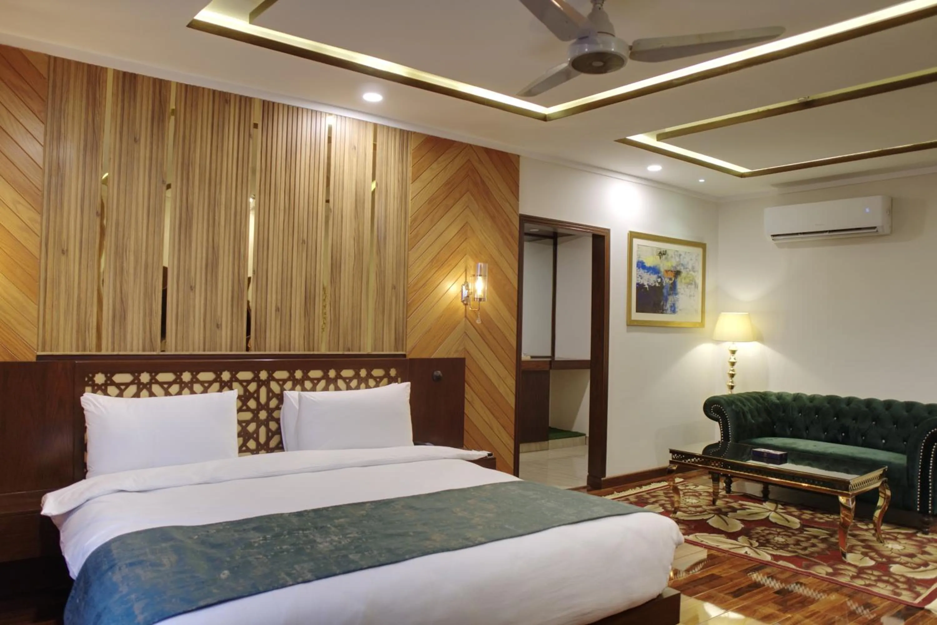 Seating area, Bed in Hotel Tourmaline Peshawar