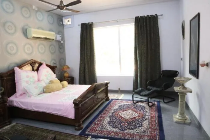 Bed in PRITHVI FARM COTTAGE AND VILLA