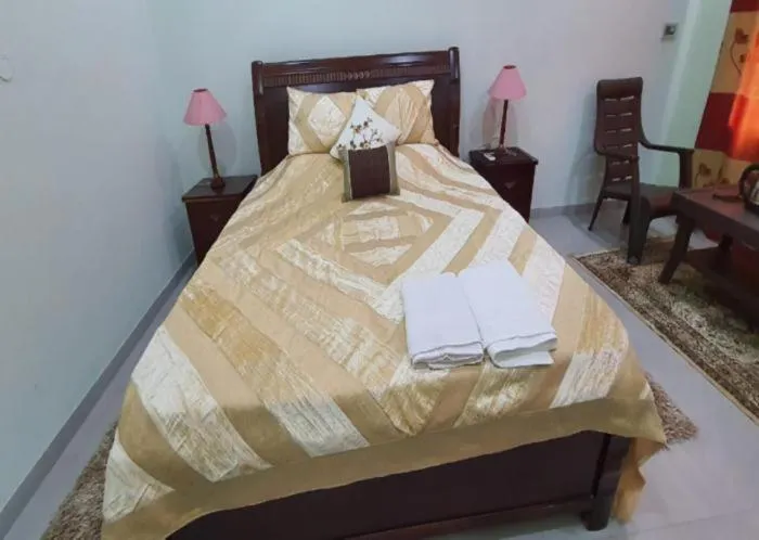 Bed in PRITHVI FARM COTTAGE AND VILLA