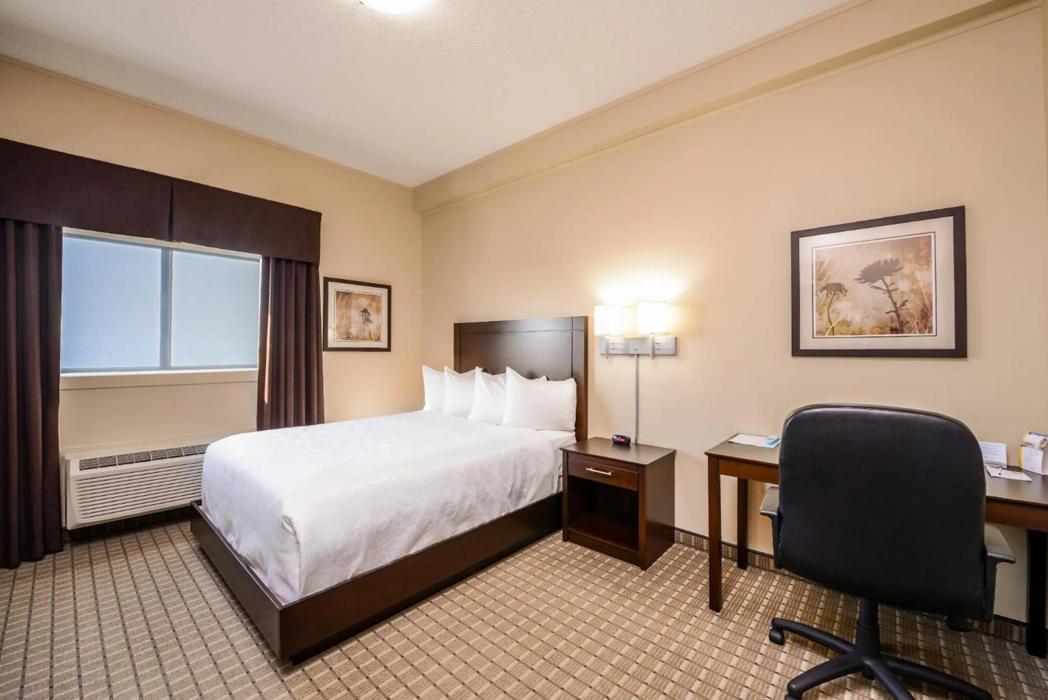 Bed in Kindersley All Suites Hotel