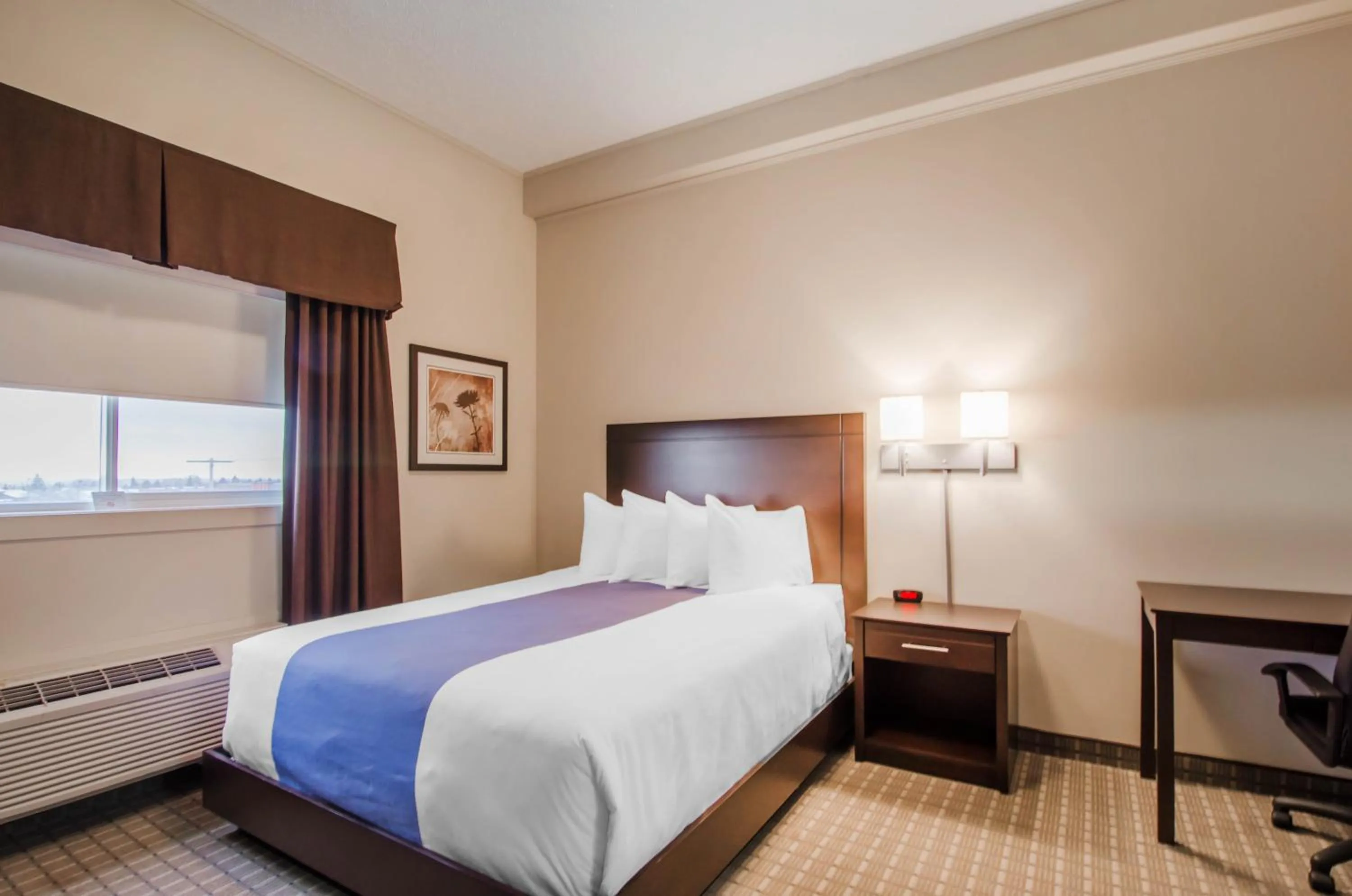 Bed in Kindersley All Suites Hotel