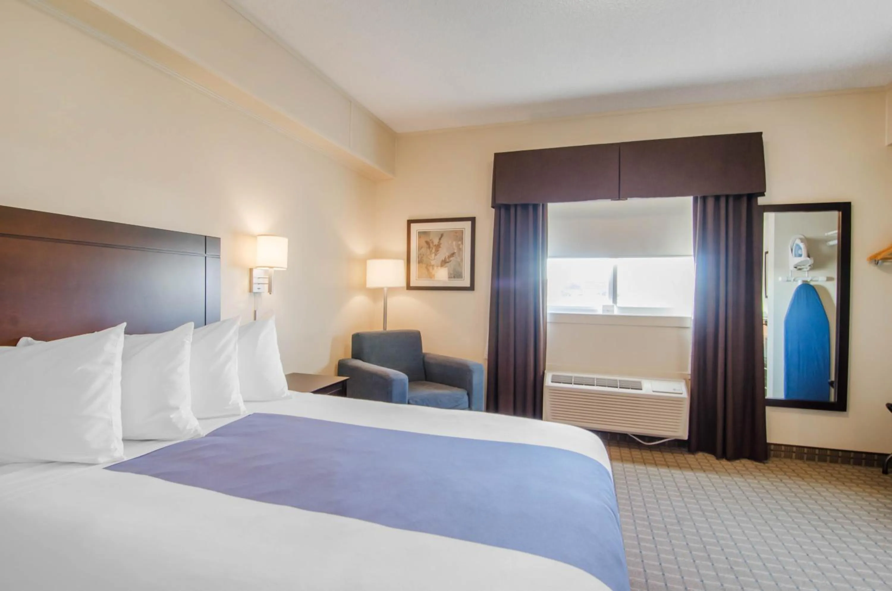 Bed in Kindersley All Suites Hotel