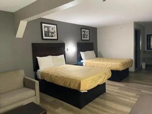 Bed in Speedway Inn & Suites