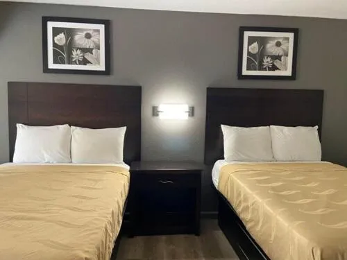 Bed in Speedway Inn & Suites