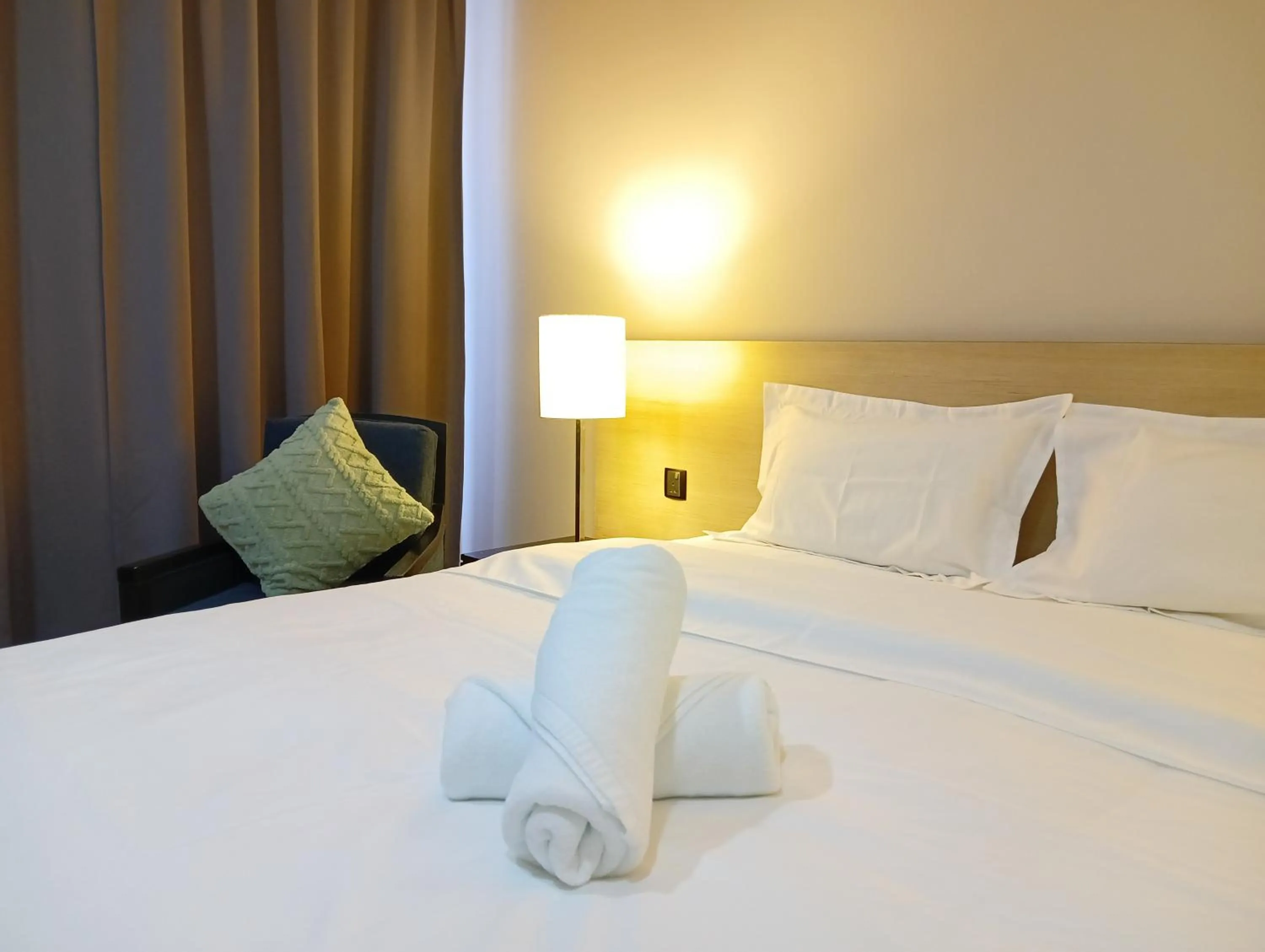 towels, Bed in The Straits Suites by Ciconia