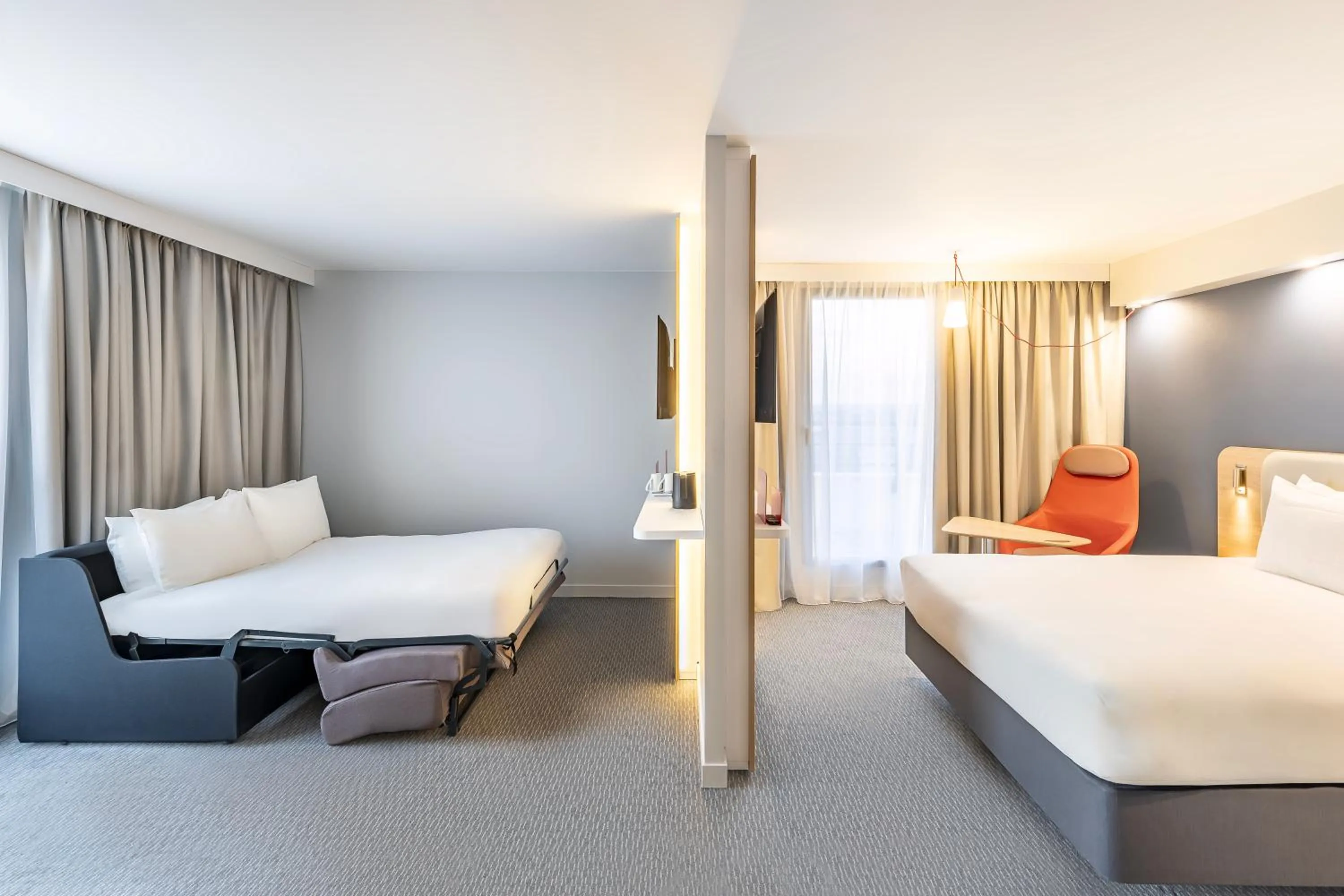 Living room, Bed in Holiday Inn Express Paris - Poissy by IHG