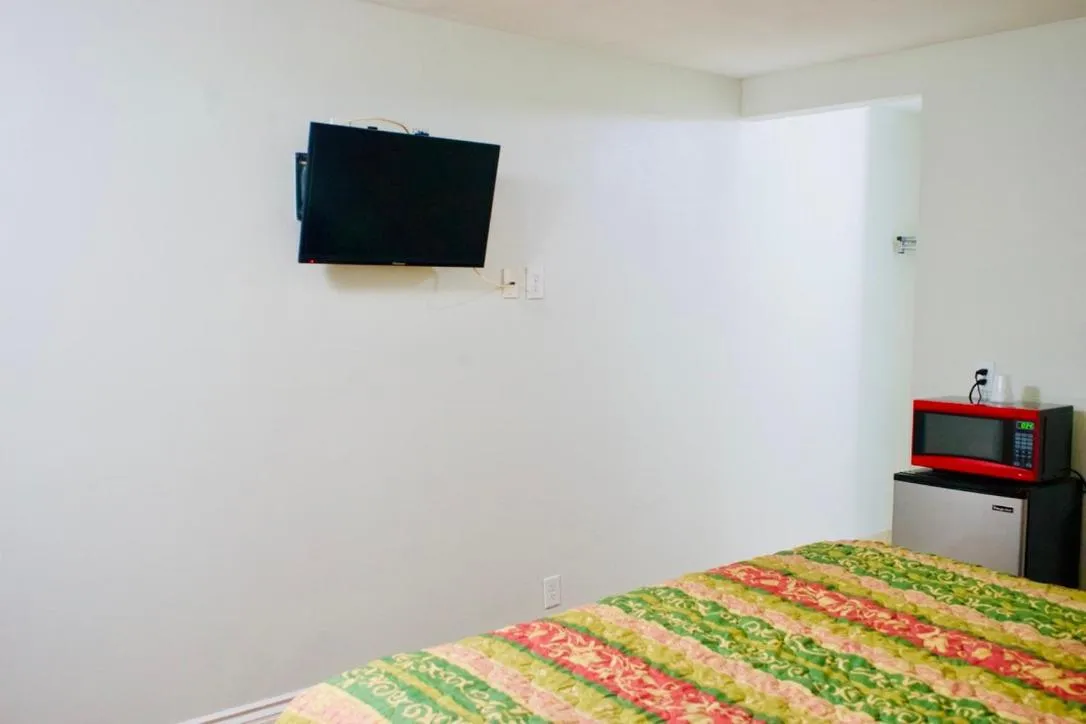 Bed in Red Carpet Motel By Ontario