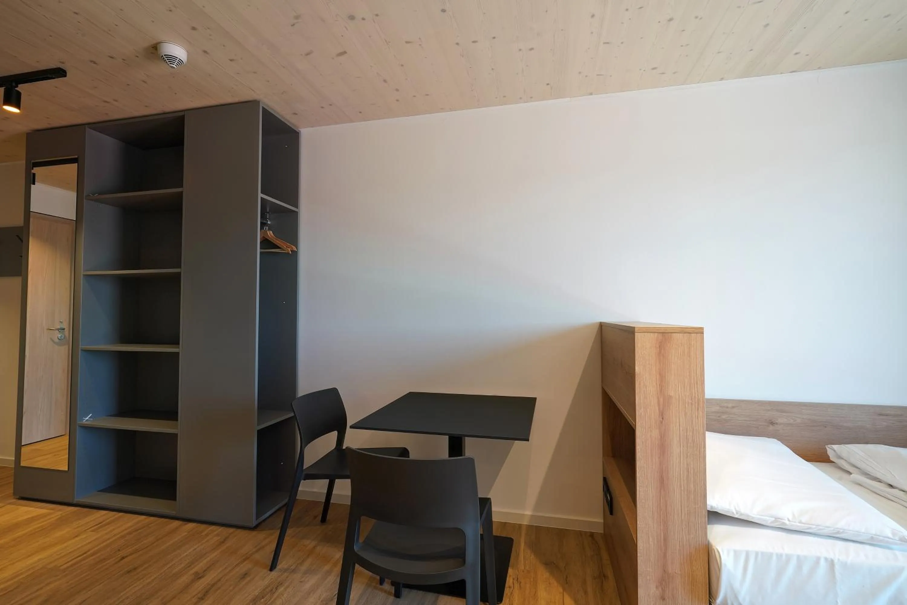 wardrobe, Bed in Timber One Boardinghouse Dorfen