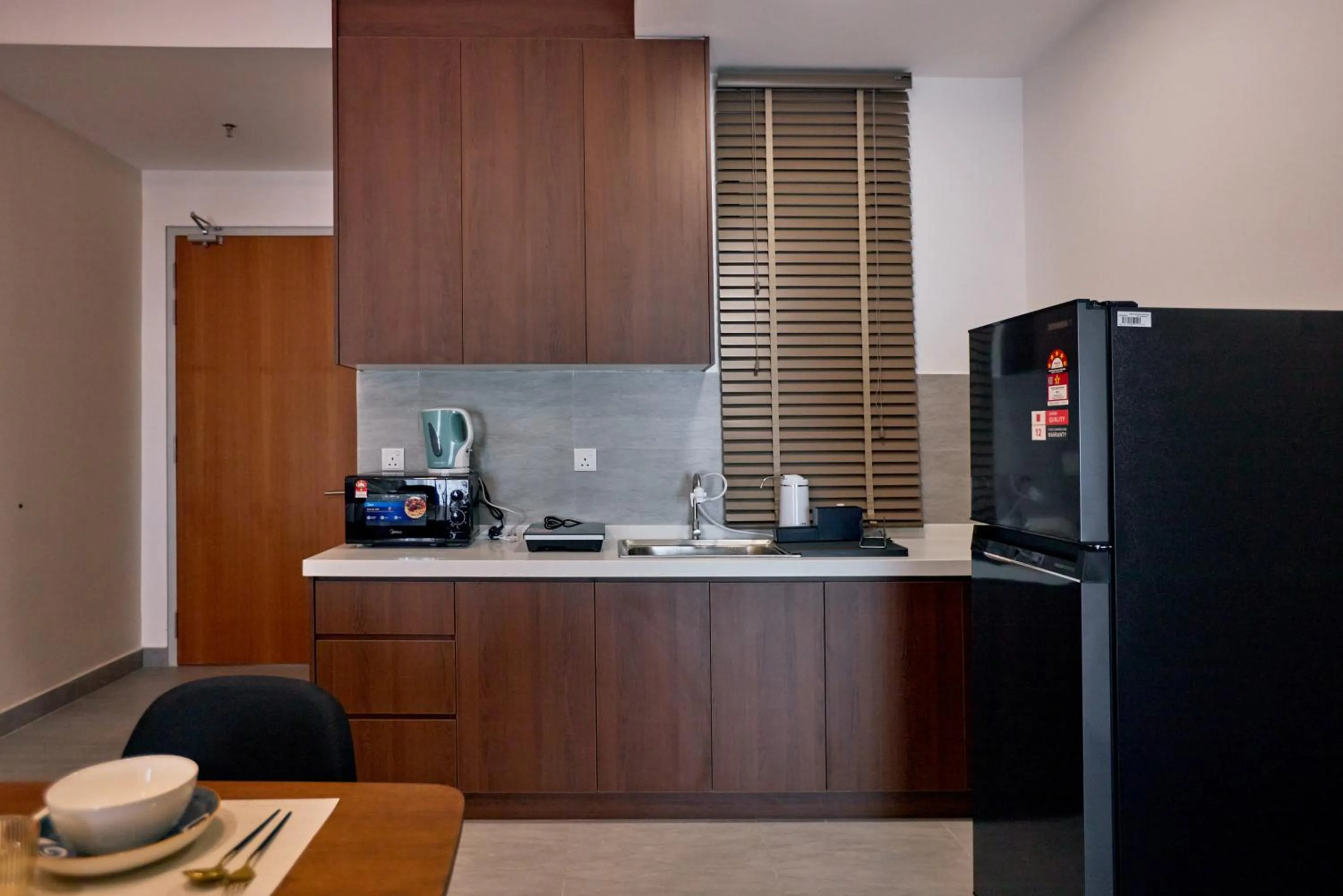 Kitchen or kitchenette in Sunsuria Forum SOHO & Residence Suites Setia Alam by MOKA