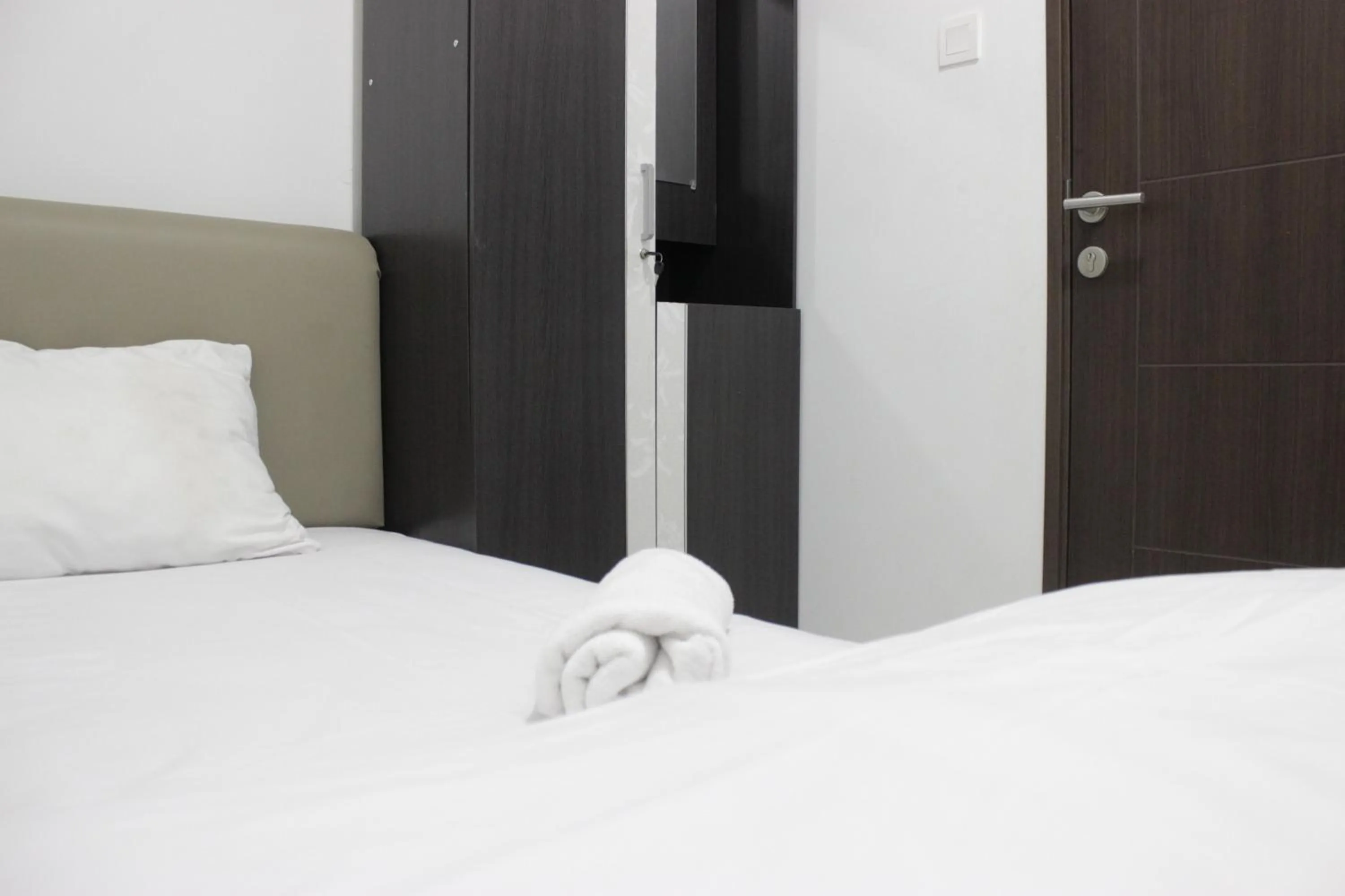 Bed in Comfy 2BR Apartment at Mekarwangi Square Cibaduyut By Travelio