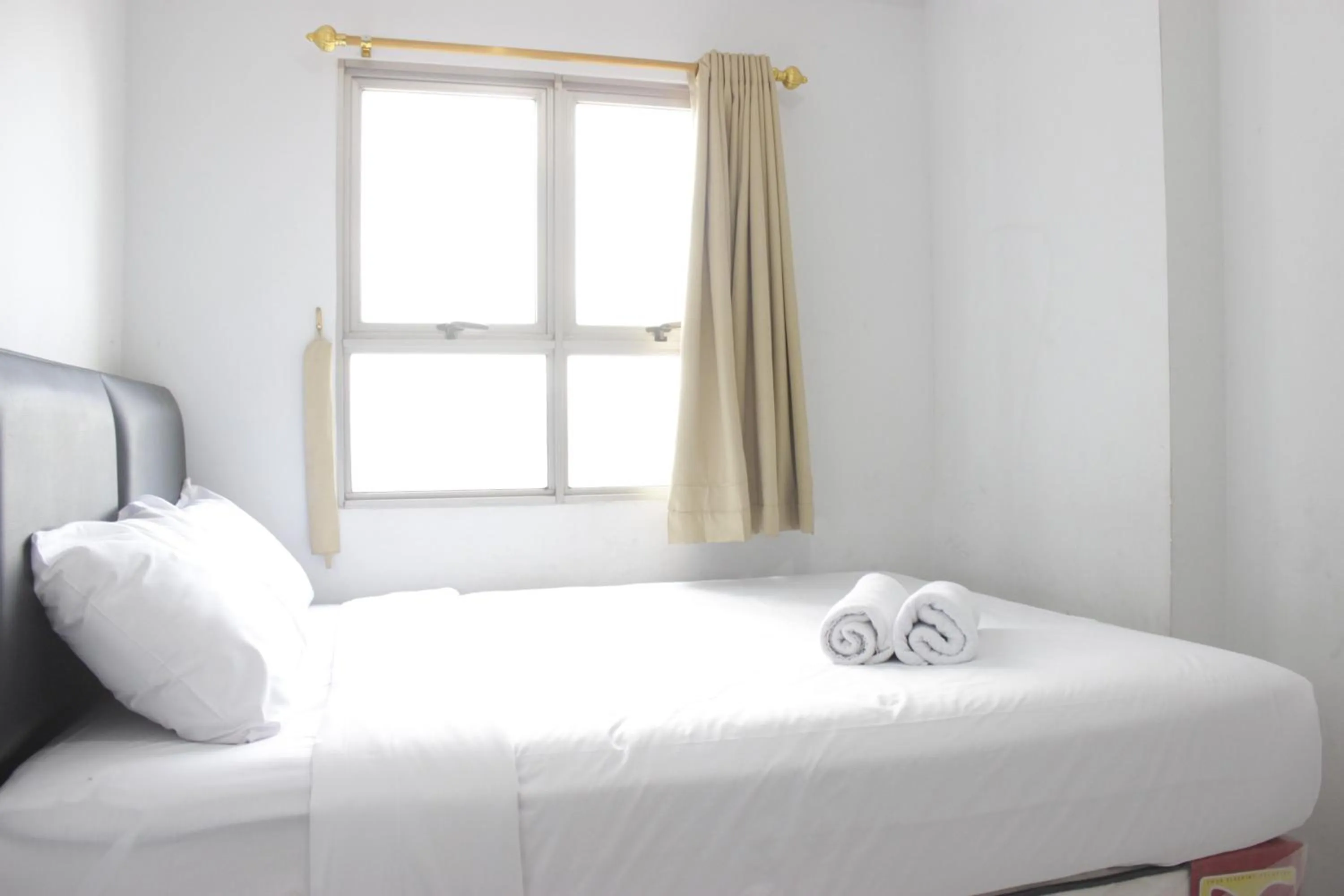 Bed in Comfy 2BR Apartment at Mekarwangi Square Cibaduyut By Travelio