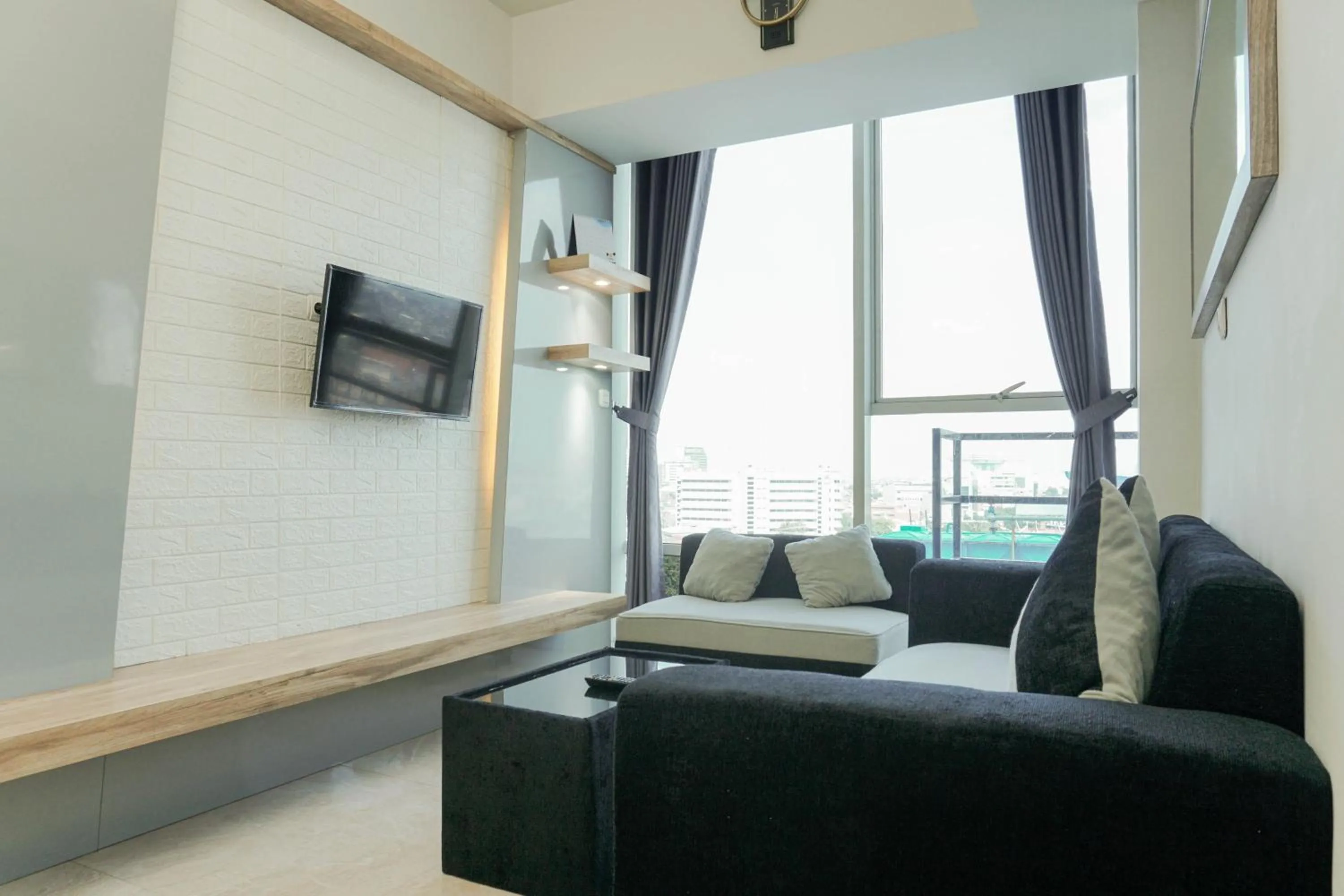 Living room in Fully Furnished with Comfortable Design 2BR Harco Mangga Besar Apartment By Travelio