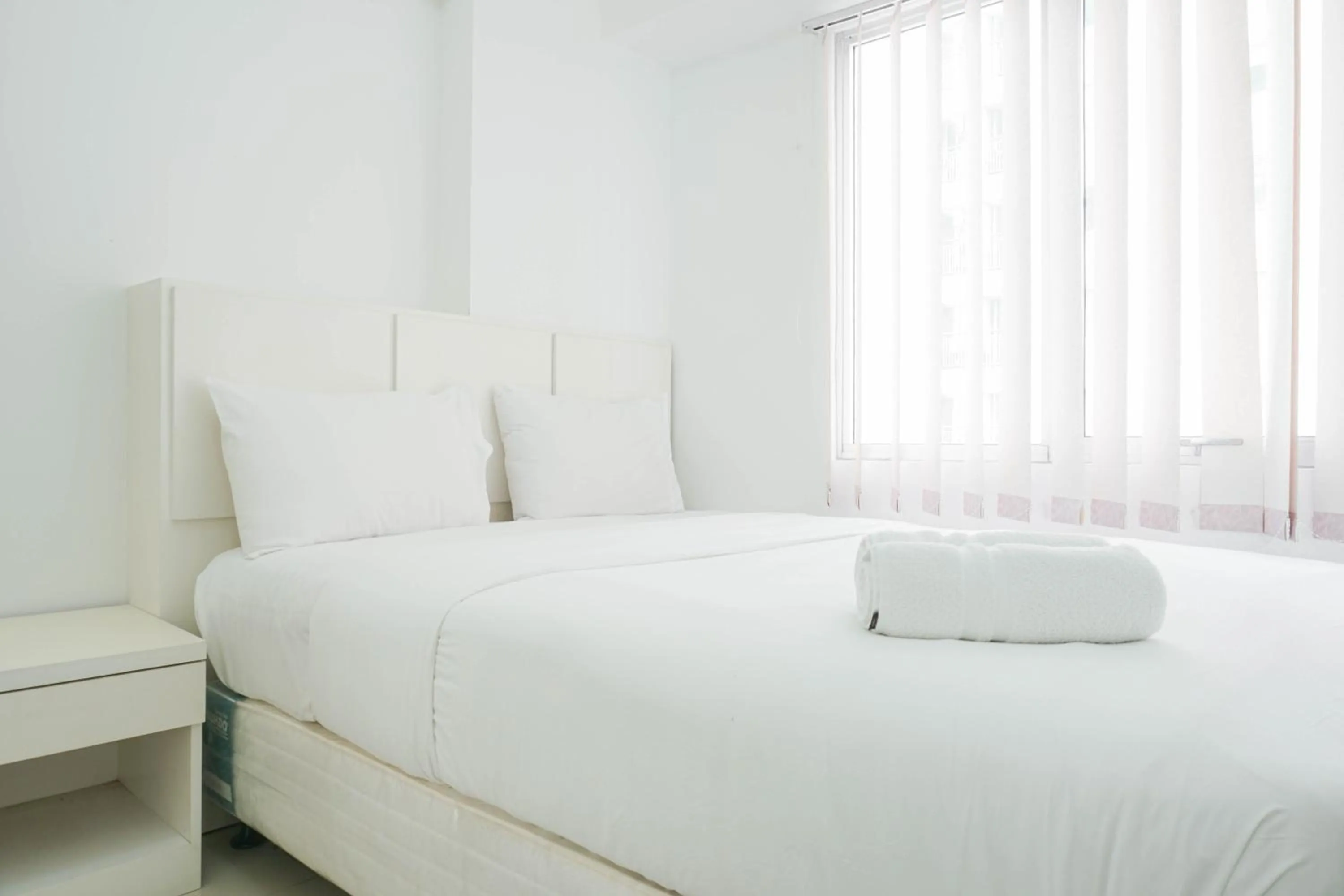 Bed in Elegant 2BR at Bassura City Apartment By Travelio