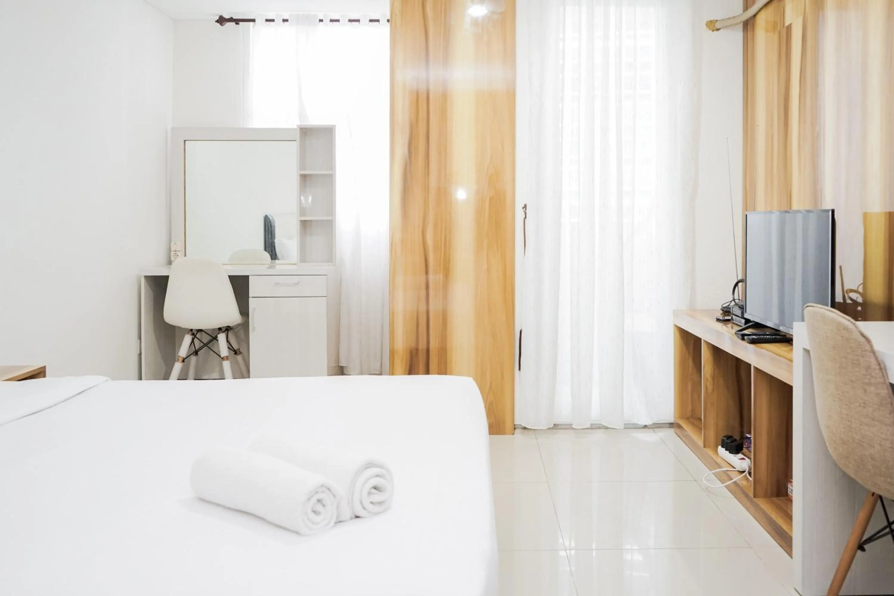 Bed in Functional Studio Apartment at Tuscany Residences BSD City By Travelio