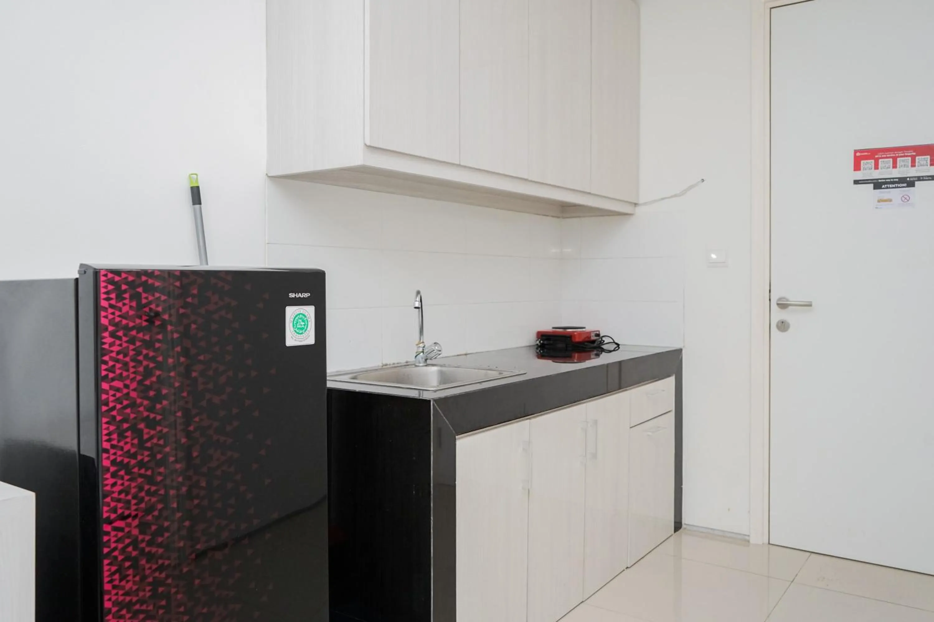 Kitchen or kitchenette in Functional Studio Apartment at Tuscany Residences BSD City By Travelio