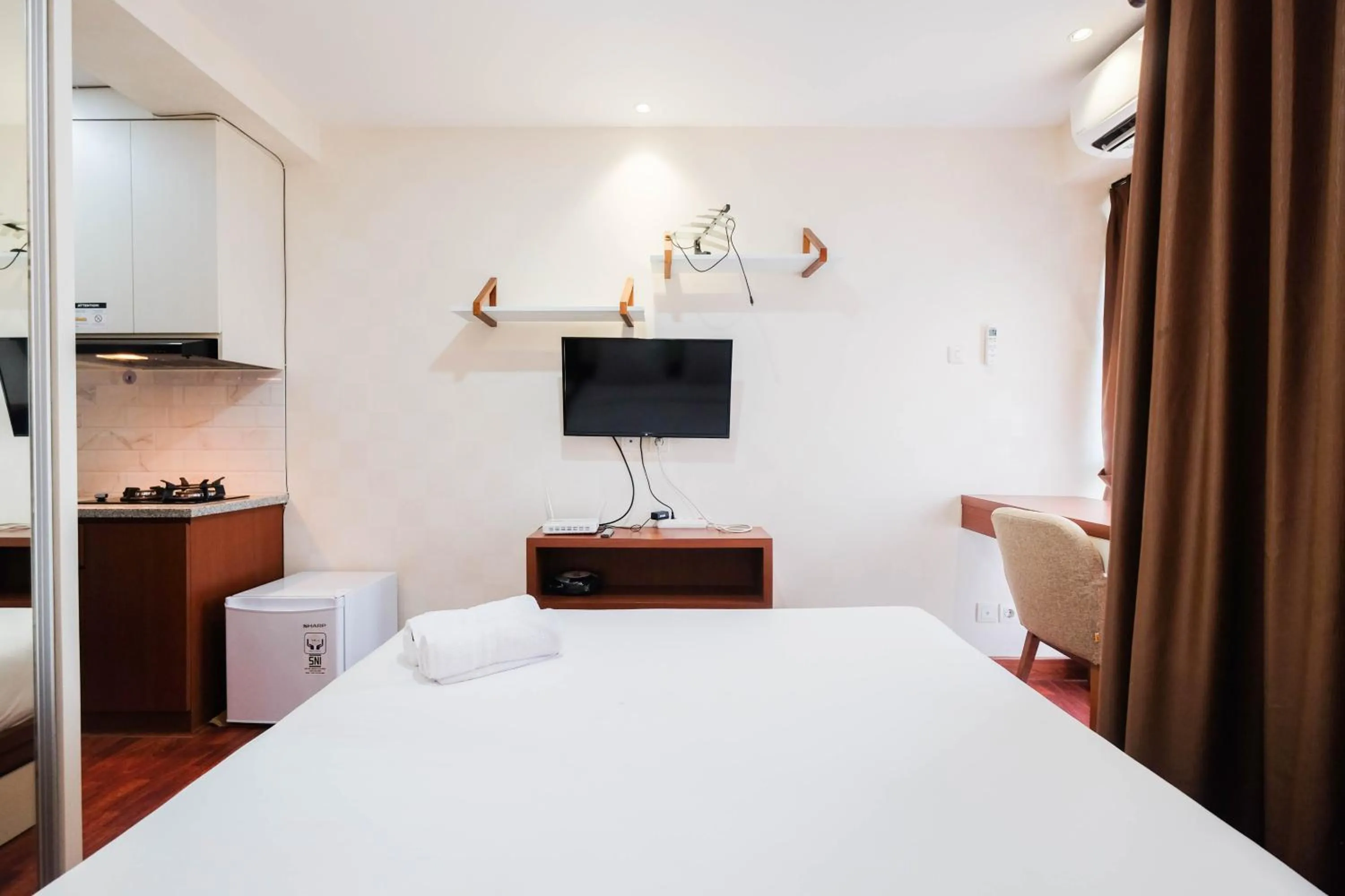 Bed in Cozy and Simply Studio Tifolia Apartment near Kelapa Gading By Travelio
