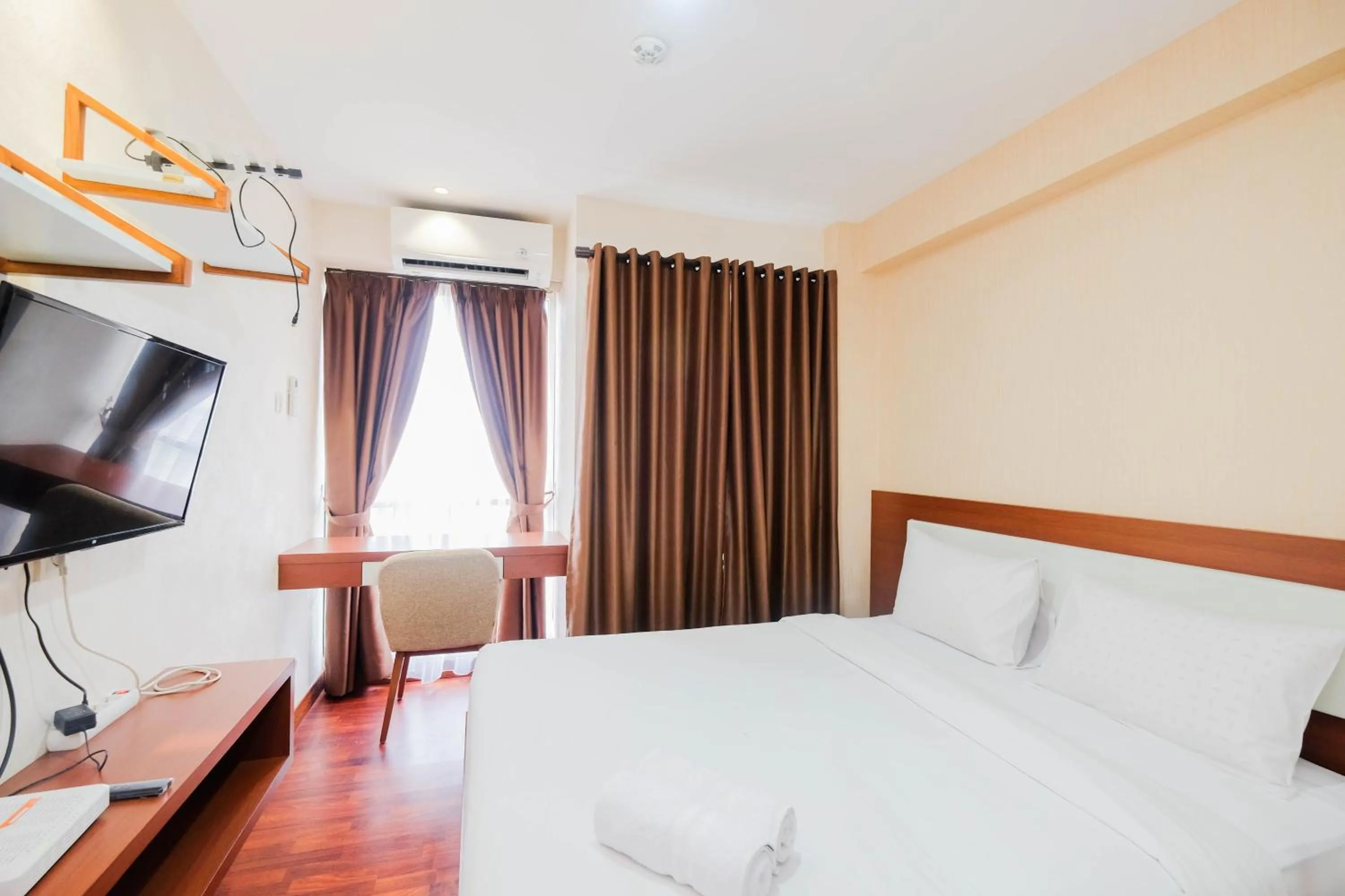 Bed in Cozy and Simply Studio Tifolia Apartment near Kelapa Gading By Travelio