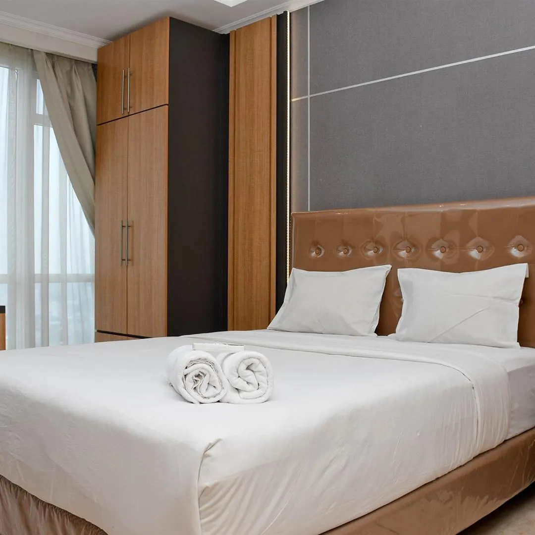 Bed in Cozy Living Studio at Menteng Park Apartment By Travelio