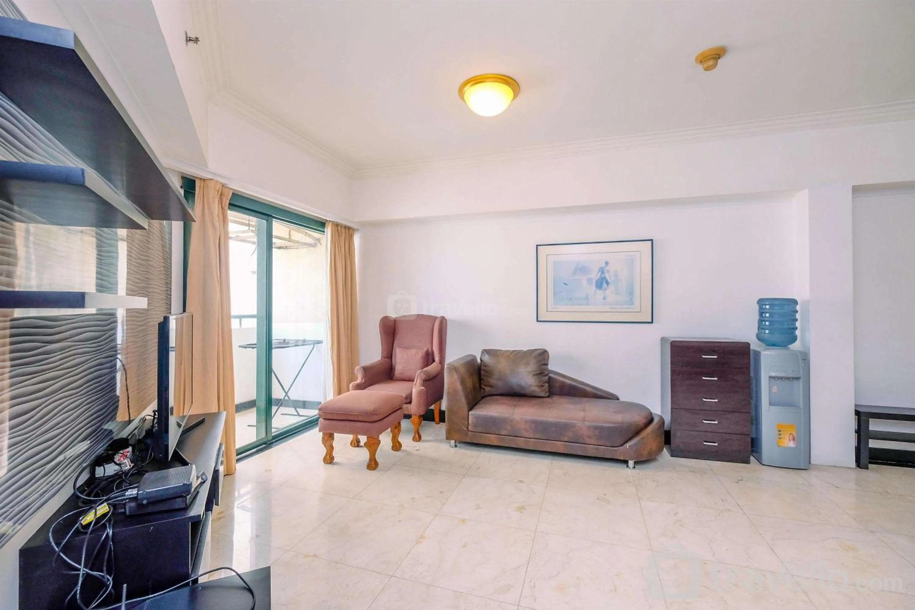 Living room in Comfort 2BR + Extra Room at Sudirman Tower Condominium Apartment By Travelio