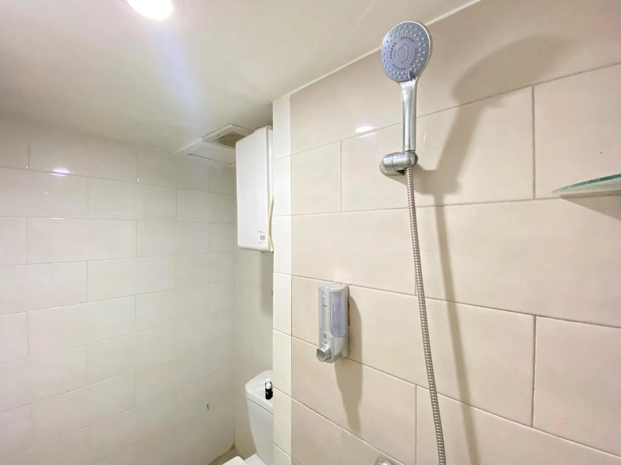 Bathroom in Cozy Living 2BR Apartment at Jarrdin Cihampelas By Travelio