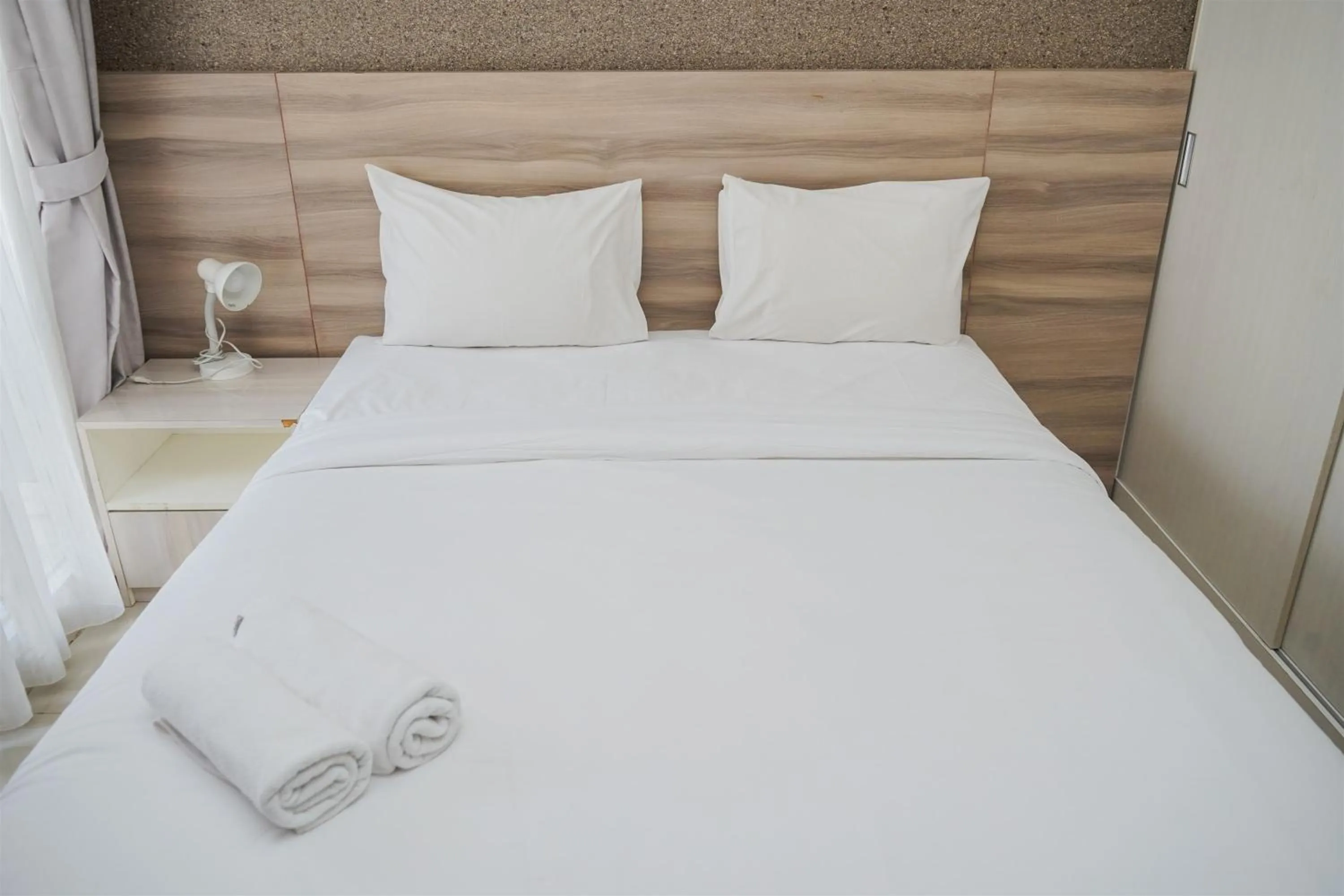 Bed in Cozy Stay Studio at Paramount Skyline Apartment By Travelio