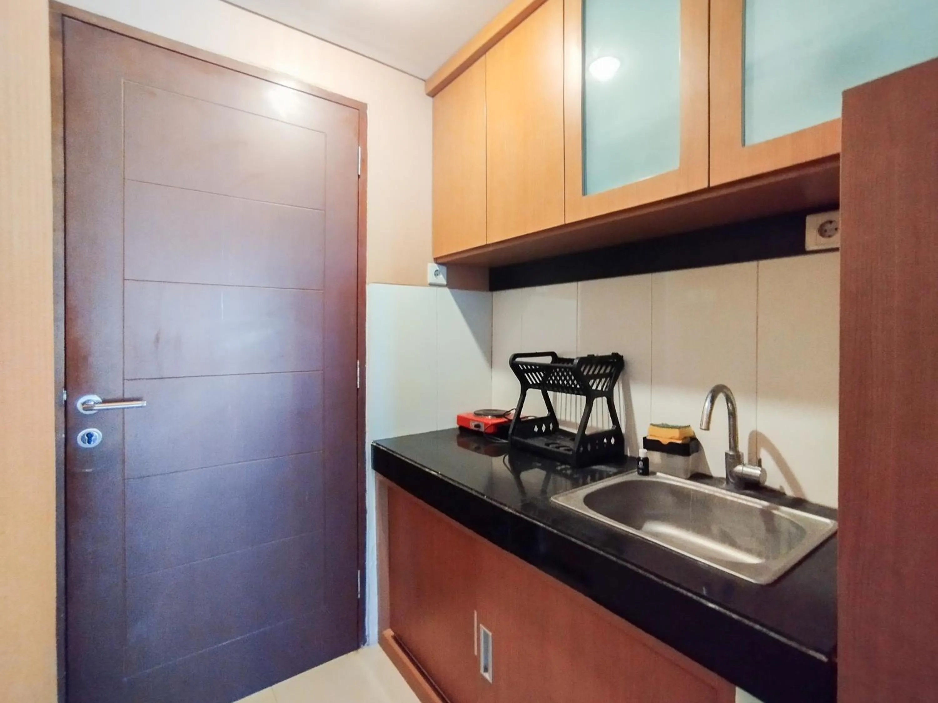 Kitchen or kitchenette in Spacious Chic Studio Room Apartment at Gateway Pasteur By Travelio