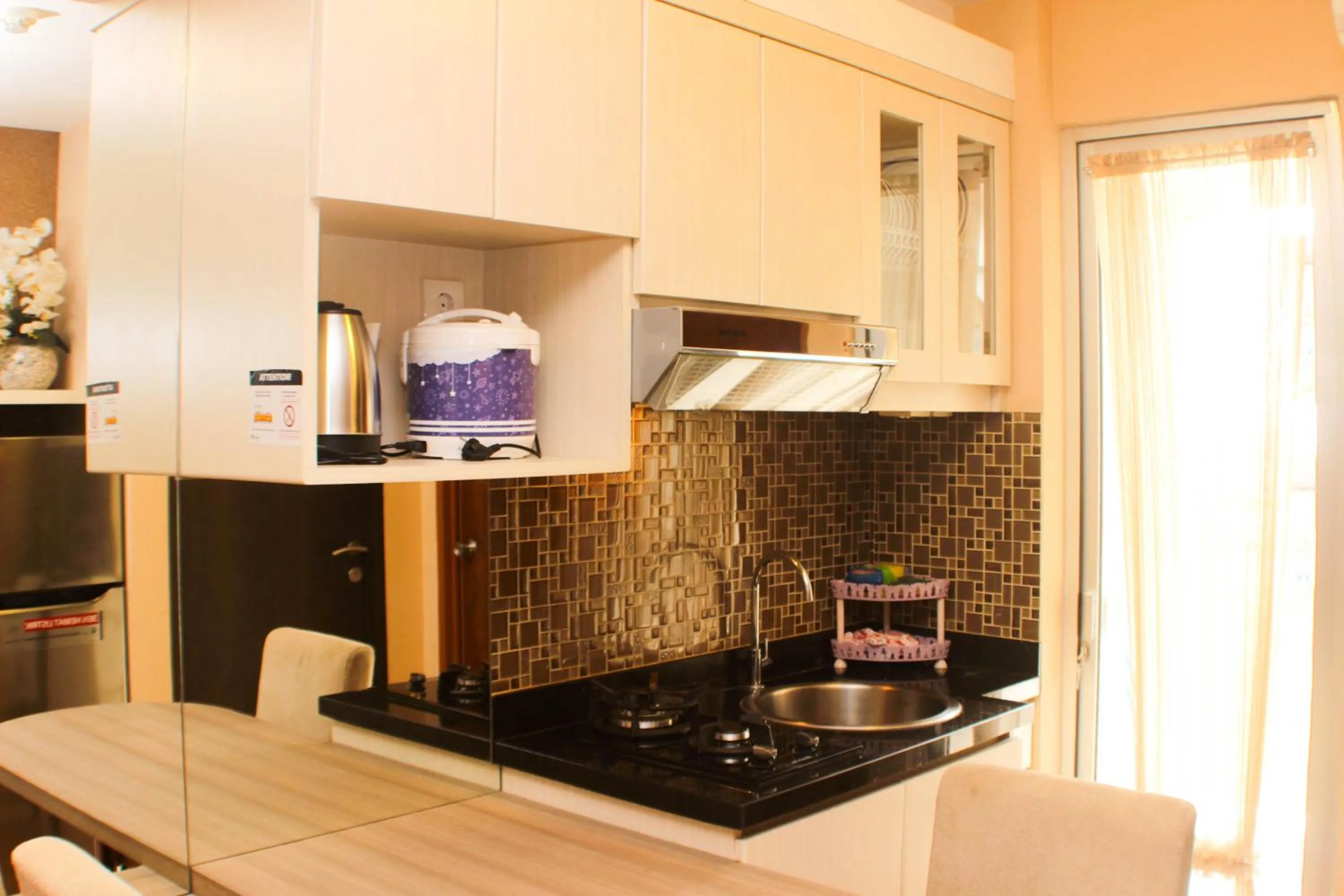 Kitchen or kitchenette in Strategic and Simply 2BR at Bassura City Apartment By Travelio