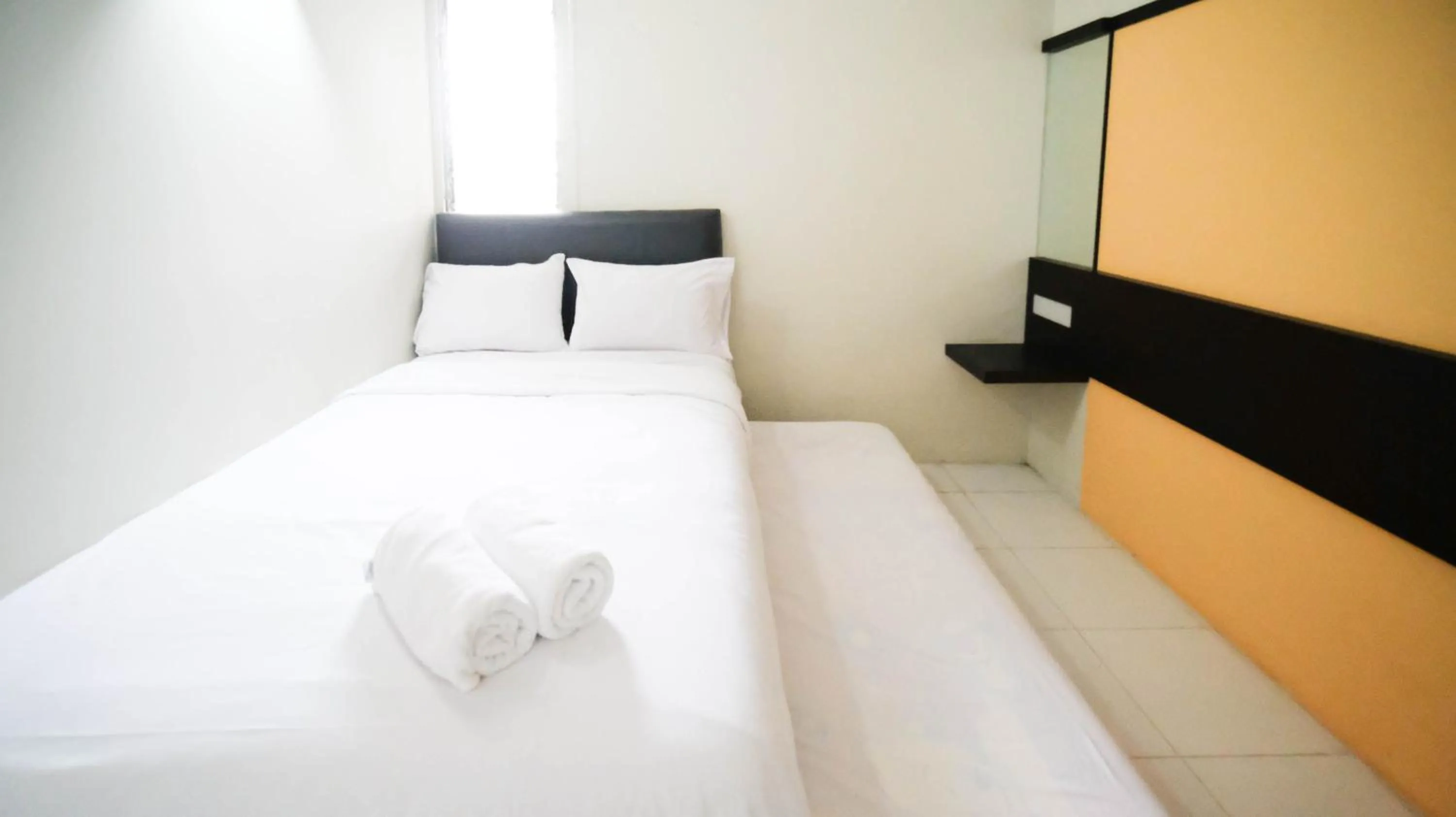 Bed in Homey and Comfy 2BR at Dian Regency Apartment By Travelio
