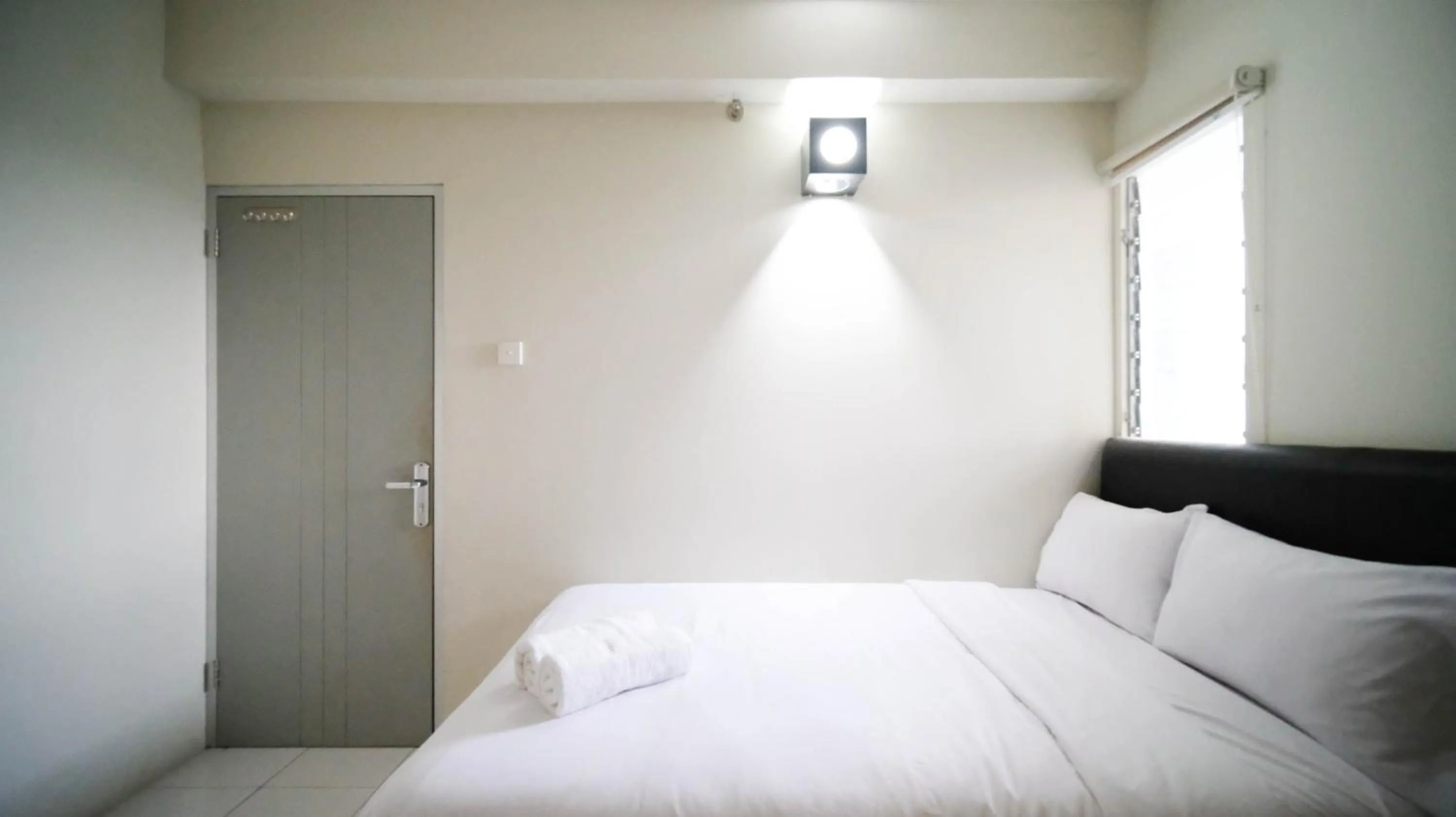 Bed in Homey and Comfy 2BR at Dian Regency Apartment By Travelio