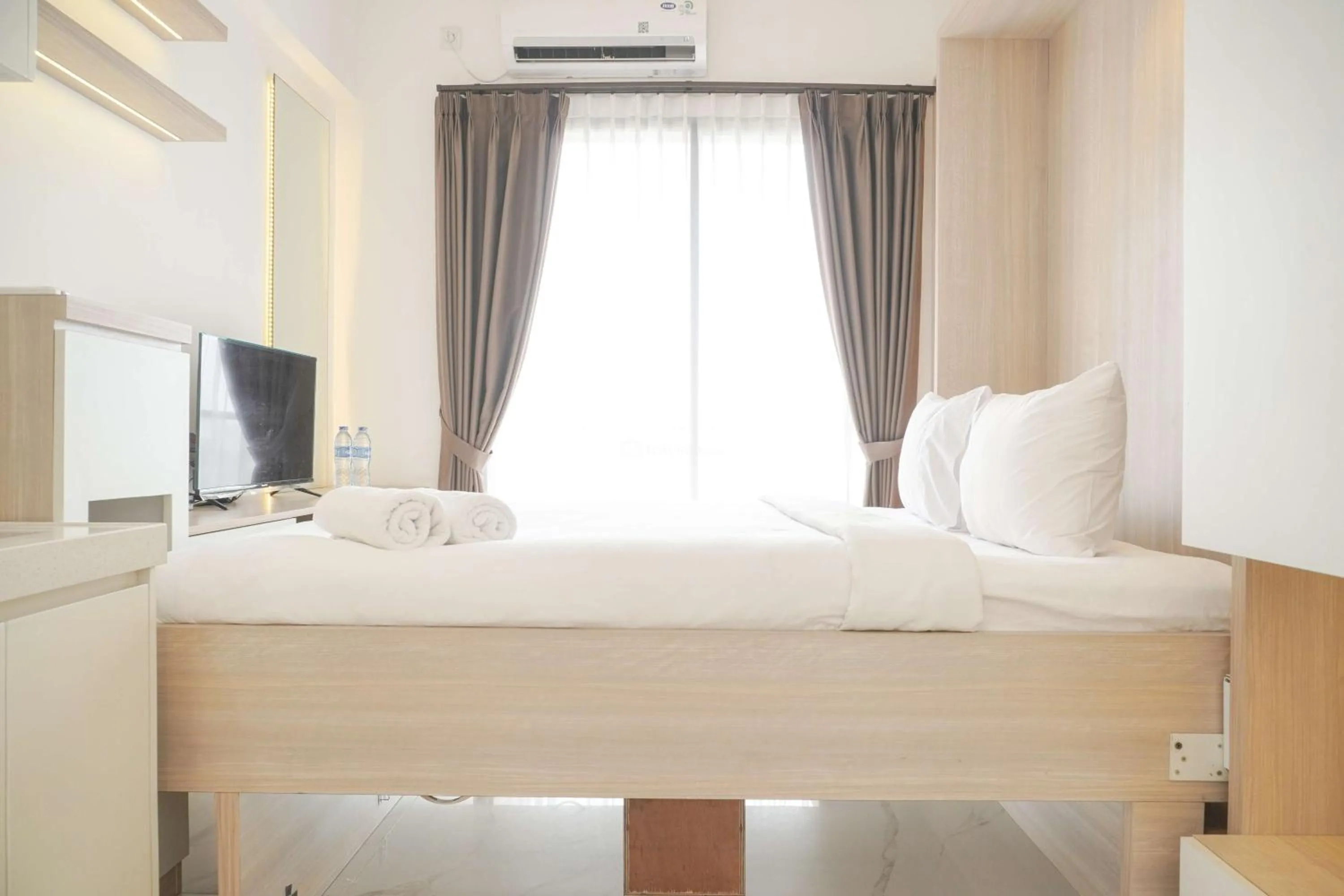 Bed in Best Choice and Nice Studio at Sky House BSD Apartment By Travelio